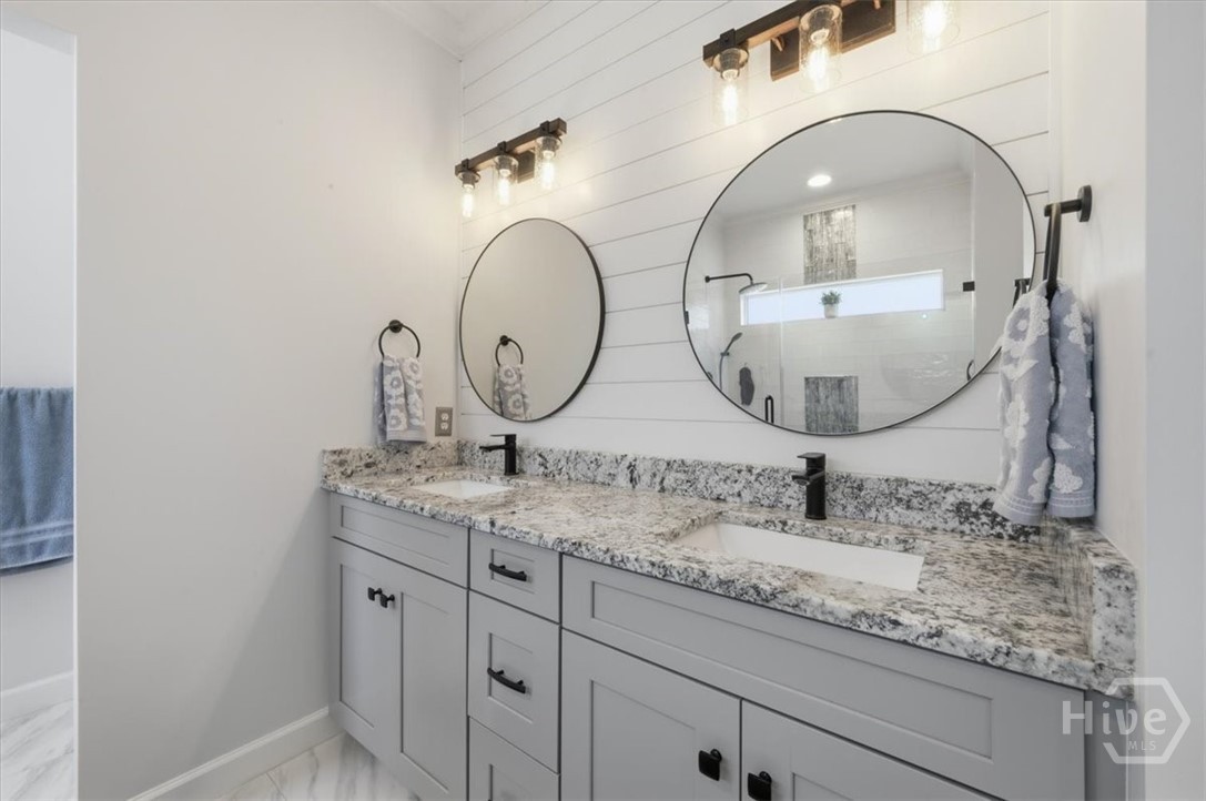 His and her raised vanities, framed sinks and new counters.