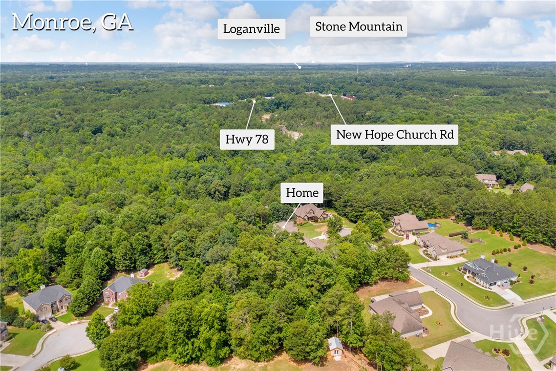 An aerial perspective showcasing the property's setting within a wooded landscape