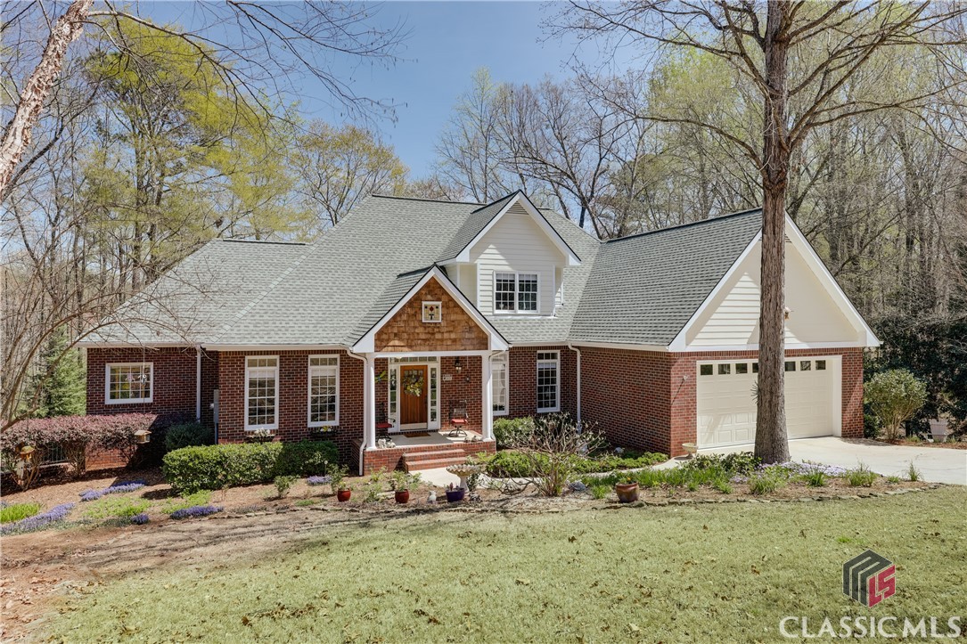 Welcome to 2140 Keeneland Drive, this exceptional brick home, nestled on over five acres of land in the desirable North Oconee area.As you enter through the bright and inviting foyer, you are immediately embraced by an open and functional floor plan. To the right, the classy dining room or sitting area seamlessly flows into a spacious living room, featuring a wood-burning fireplace with an elegant walnut mantel. The living room opens to the well-appointed kitchen, creating a sense of warmth and comfort that makes you feel instantly at home. The kitchen boasts cherry cabinetry, granite countertops, and a grand central island, complemented by a garden window that offers an abundance of natural light, ensuring a delightful cooking experience.A hallway off the kitchen leads to an oversized laundry room with a sink and expansive cabinetry, a convenient half bathroom, and a two-car garage complete with additional cabinets and industrial-grade epoxy flooring for durability and style.On the opposite side of the home, you will find the tranquil primary suite, along with an office or study and a well-placed coat closet. The owner’s suite is a serene retreat, featuring large windows overlooking the private lot, an en-suite bathroom with a walk-in closet, generous cabinet space and elegant cultured marble countertops. The main level is adorned with beautiful hardwood flooring, adding an extra touch of sophistication.Upstairs, the home offers three spacious bedrooms and two full bathrooms, providing ample room for comfortable living.The two-tier rear deck, accessible from both the kitchen and terrace level, invites you to enjoy the peaceful outdoor oasis, offering a perfect space to unwind and embrace the beauty of nature. The partially finished terrace level, featuring a full bathroom, numerous windows, two exterior doors, as well as a rollup door is ready to be customized to suit your needs.The fenced backyard is a nature lover’s paradise, with winter grass, home to an impressive variety of tree species, including Japanese lace-leaf maples, Redbud, Savannah Holly, Little Gem Magnolia, Redwoods, and Cypress trees, creating a tranquil retreat. In total, over 35 varieties of plants, including a vibrant array of flowering species, and 16 tree species transform the front and backyard into a stunning, personal botanical garden.Convenient to Dove Creek Elementary and Middle Schools, Prince Avenue Christian School, shopping and restaurants, this home offers the perfect balance of tranquility, convenience, and access to the amenities you need.With its prime location and elegant design, 2140 Keeneland Drive is the ideal blend of comfort, work, and entertainment. Make this charming home yours! xx