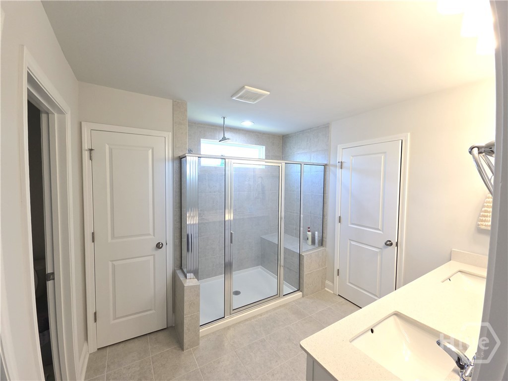 Spacious Owner's Suite on 2nd Level has oversized Tiled Shower, Double Vanities and His & Her Closets.