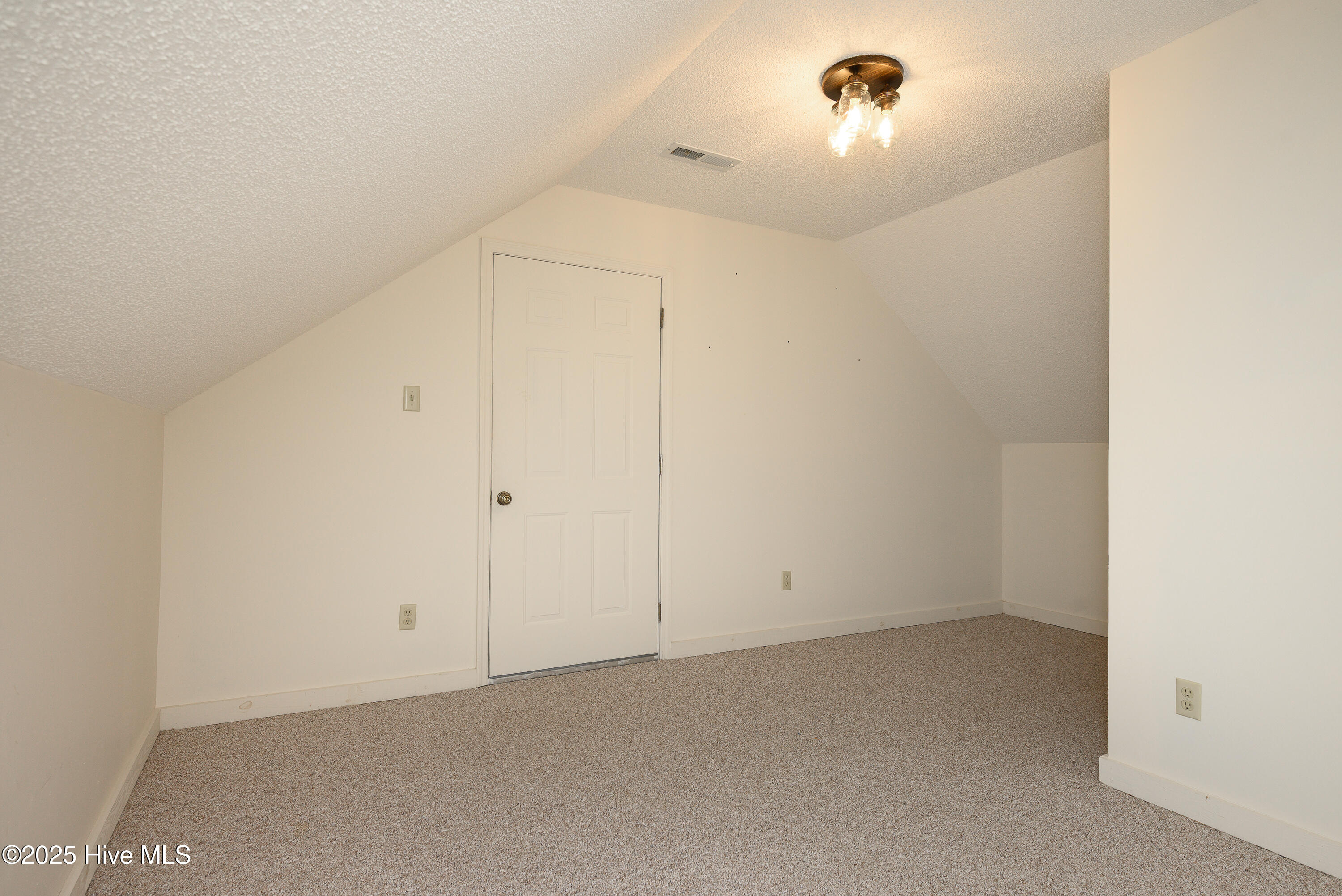 3rd bedroom upstairs with walk in access to storage space above garage
