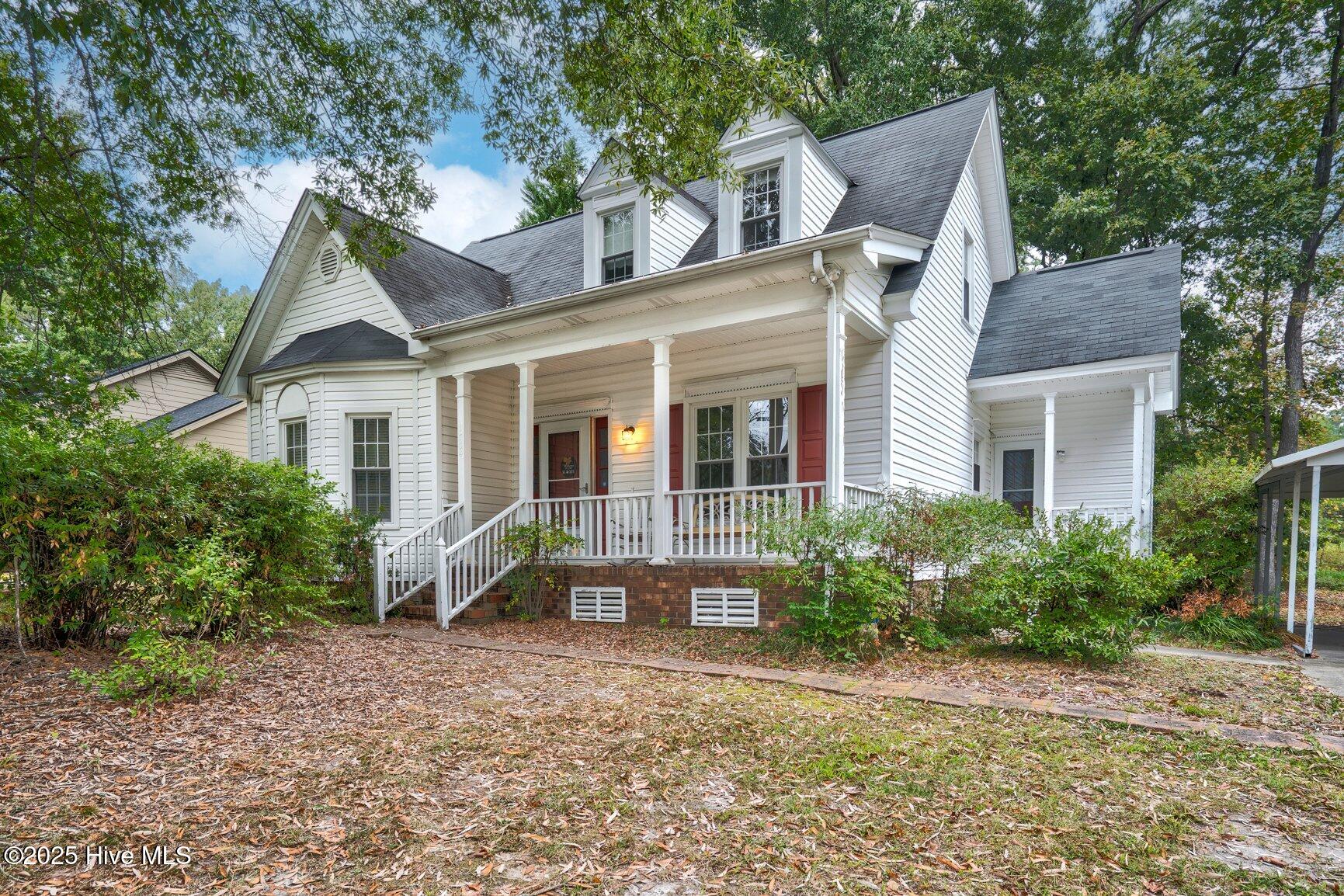 Welcome to 1704 Old Barn Rd - a charming 3-bedroom, 2-bath home offering comfort, space, and convenience in a prime Rocky Mount location. The spacious living room features a cozy fireplace and triple windows that fill the space with natural light. Enjoy meals in the formal dining room or the eat-in kitchen, complete with a bay window overlooking the wooded backyard. The main-floor master bedroom offers a large bay window, walk-in closet, and access to a full bathroom. Secondary bedrooms upstairs include built-in bookcases for added character and storage. Outside, relax on the covered front porch under a mature oak tree, entertain on the brick patio, and enjoy the functionality of a detached single-car carport with concrete driveway and a backyard shed with shelving. Conveniently located near shopping, dining, and with easy highway access—this home is a must-see!