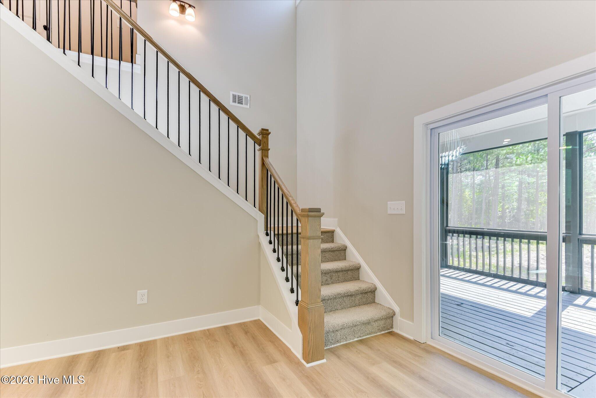 Sliding doors lead to the rear screened porch.