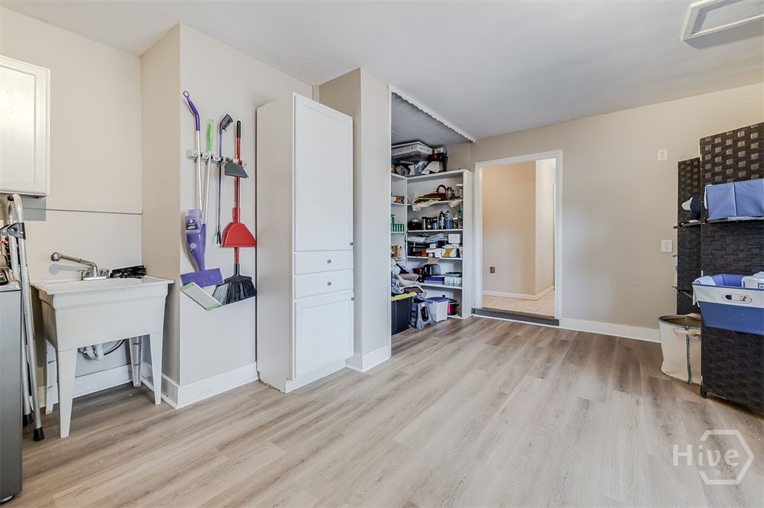 Lots of extras in this room to include the new LVP flooring, full utility sink, and a large storage area for extra pantry space or whatever you need to store.