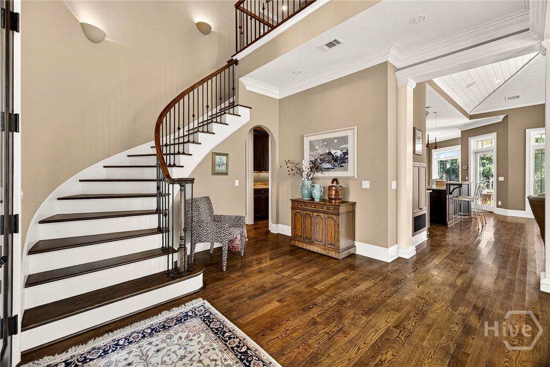 2 Story foyer is adorned by the spiral staircase a