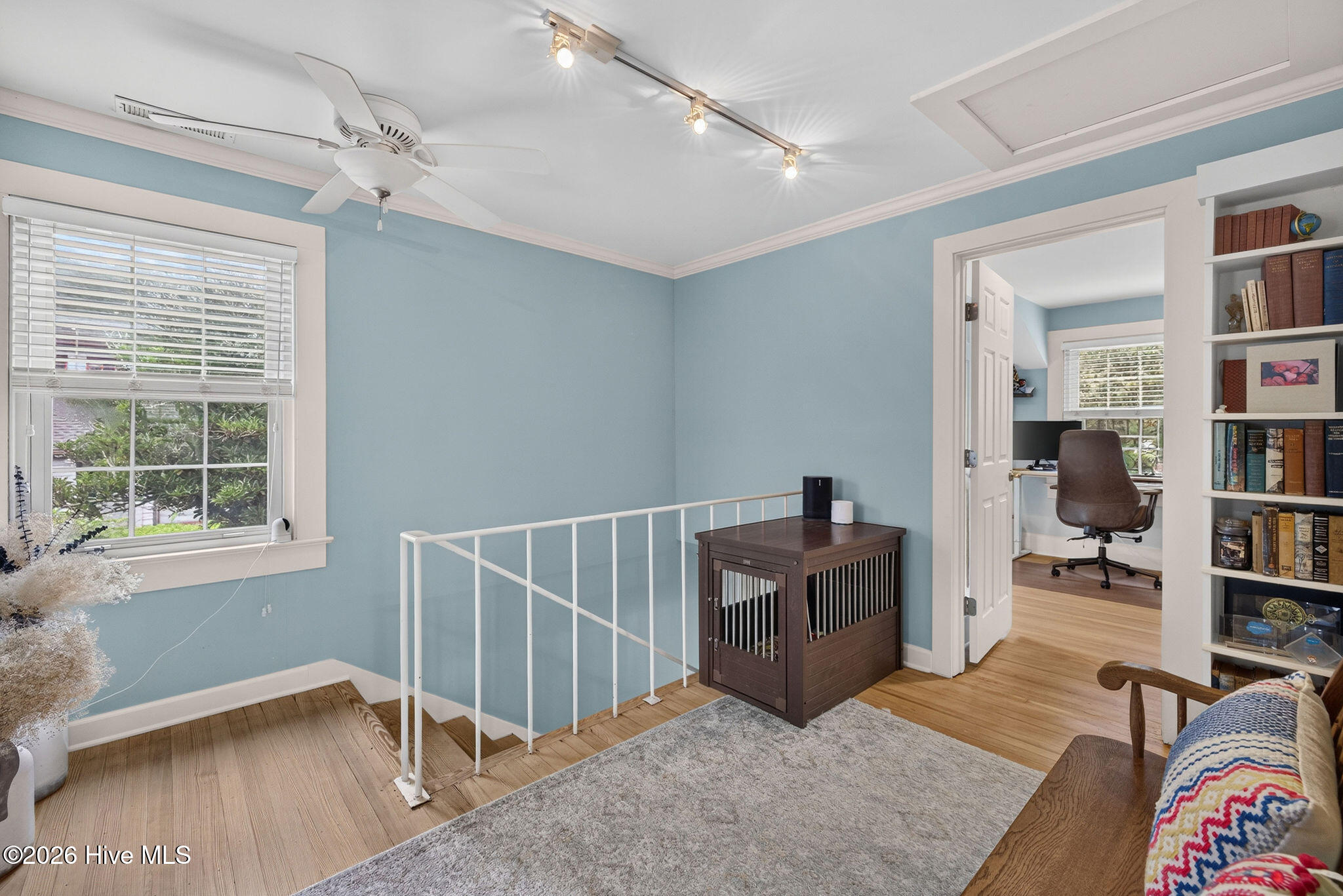 Upstairs landing with built-ins and beautiful hardwood floors throughout the entire Home.