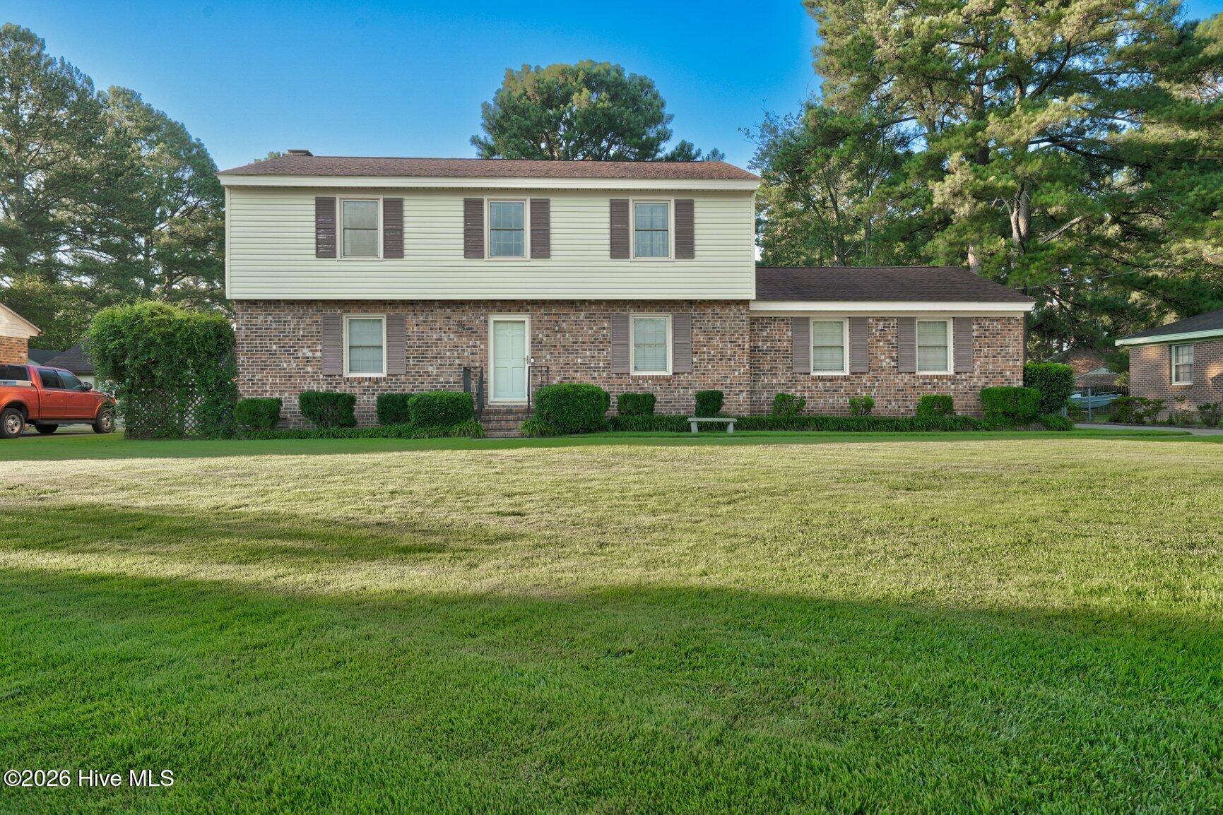 Spacious 5-Bedroom, 3.5-Bath Home with Incredible Space & Versatility! This well maintained home offers an abundance of room for living, entertaining, and everyday comfort. Beautiful hardwood floors flow through the formal dining room, living room, and den, creating a warm and inviting feel throughout the main living areas. Enjoy the convenience of a primary bedroom on the first floor, along with a spacious kitchen designed with entertaining in mind. The 18 X 12 sunroom, not included in the heated square footage  provides an additional flexible space perfect for relaxing, entertaining, or enjoying the views of the backyard. Outside, you'll find a paved driveway with additional rear parking, a fenced-in backyard, storage building, and an impressive 2-story workshop offering endless possibilities for hobbies, projects, storage, or a home business. With 5 bedrooms, 3.5 baths, multiple living areas, and incredible outdoor space, this is a home you won't want to miss! Call today for your private showing!
