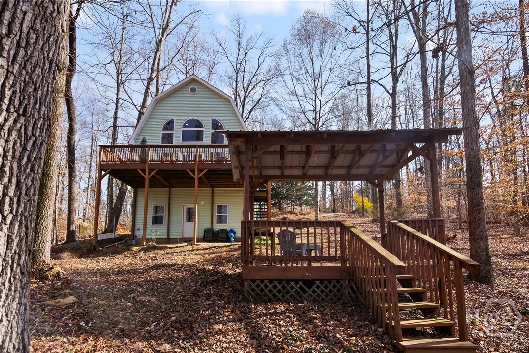 Take a look at this adorable and affordable home on Lake Hartwell! Whether you've been searching for a weekend getaway or an income producing property, 78 View Point Place checks both boxes. Enjoy access to and views of Lake Hartwell, mature trees, and slip that Kayak right on in! If you've seen this home before, look again - the current owner recently completed a full renovation of both bathrooms, installed a new water heater, painted the interior & kitchen cabinets, and scraped all popcorn ceilings! A beautiful wall of windows in the Greatroom is immediately visible upon entry, and the 16ft ceilings paired with those windows, the wooded lot and lake views create a private oasis. The eat-in kitchen is complete with freshly painted cabinets, newer black stainless appliances, and Corian countertops. The main floor bedroom is across the entry hall from a brand new bathroom with tiled shower, tile floors, and new vanity. Upstairs is the primary suite with new ensuite bathroom complete with tub and tiled surround. A large barn door compliments the wood accent wall and adds privacy to the Primary Suite. There's even a private Juliet Balcony for morning coffee. The spacious deck overlooking Lake Hartwell has plenty of room for friends and family to hang out, crack open a Corona or two, and enjoy every season. Grab the floats, kayaks, or canoes and slip into the water or bring the boat and utilize the nearby boat ramps: Franklin Co Boat Ramp (2.2mi) and Tugaloo State Park & Gumlog Boat Ramp (3.3mi). There is a gazebo on the property for more outdoor enjoyment as well. Conveniently located 5 minutes from I-85, this makes for an easy drive from Athens or Metro Atlanta.