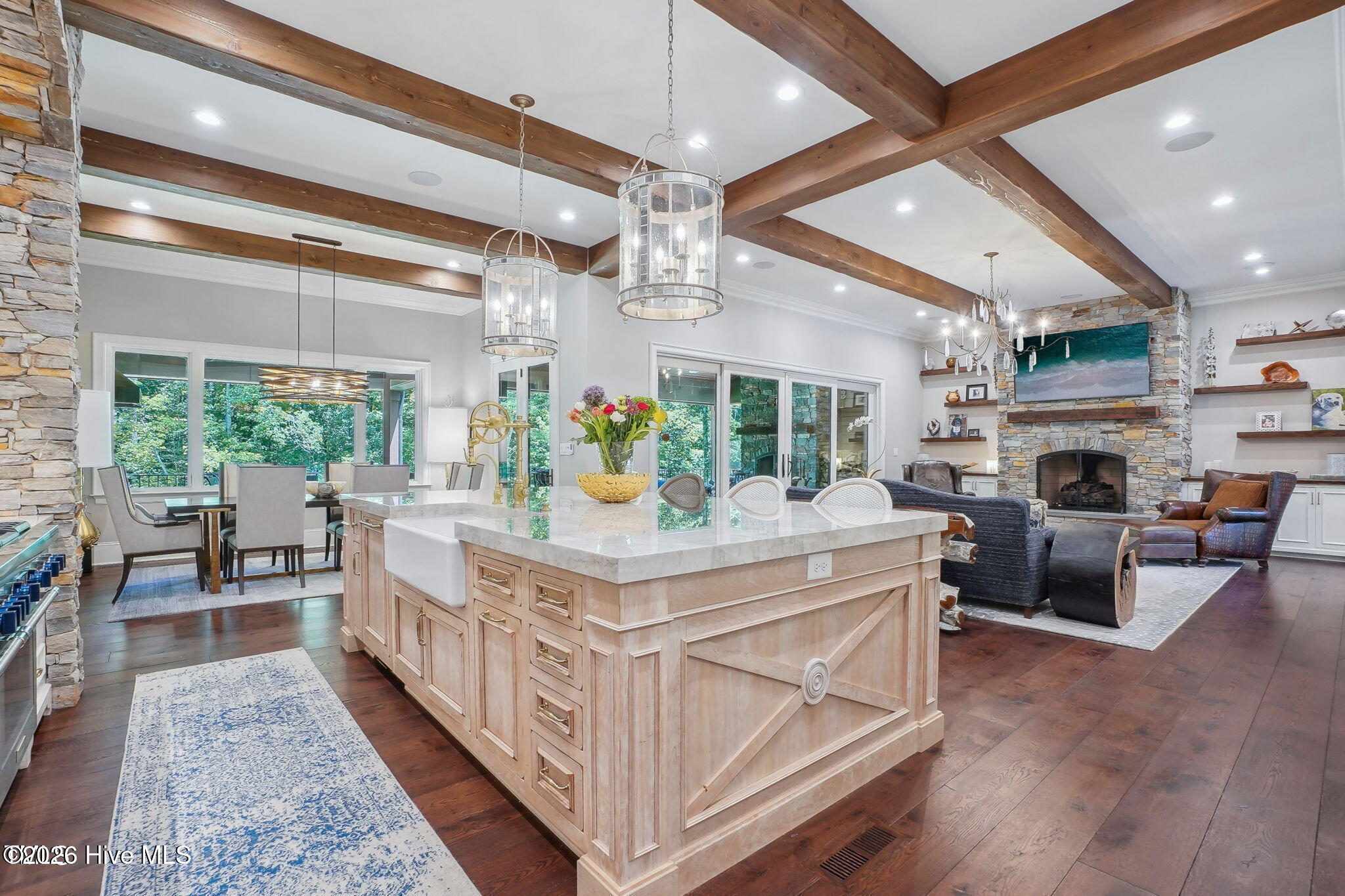Huge single slab laminated island with hidden Miele dishwasher dovetail drawers