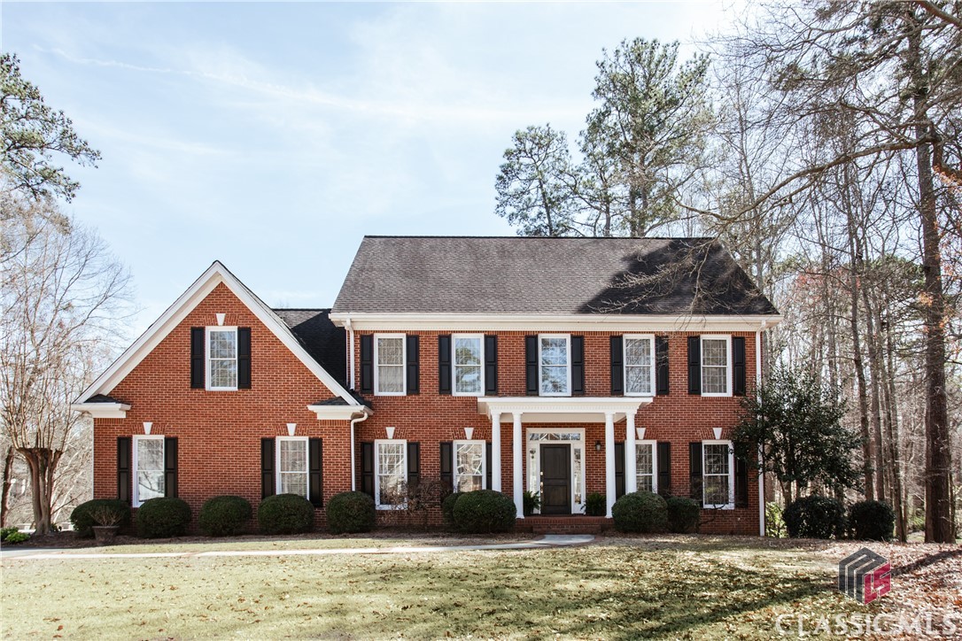 Under Contract prior to Marketing! Traditional elegance exudes from this lovingly maintained brick Georgian in the coveted Jennings Mill development. Located on over an acre, the  home is accented by lush landscapes and a serene water feature.A two story foyer welcomes you from a lovely covered front porch, and you will be in awe of the crisp, bright walls and abundance of natural light. A spacious formal dining room is located to your left, and a living room is located to your right with French doors that connect to the rear family room. The family room has a brick fireplace and French doors that open to a newly built deck, creating a wonderful every day living space.The heart of the home, as with most, is the renovated kitchen with quartzite countertops, new appliances and lighting, all open to a large keeping room. This bright and open space overlooks the private rear yard and offers enough square footage for a breakfast room table, desk and sitting area. It’s hard to imagine leaving this room because of the numerous windows bringing the outside in. A powder room and large laundry room with a utility sink and ample cabinetry complete the main level. Hardwood floors span this main level and are in fantastic condition!Choose either the front or rear stairwell to access the upper level which is home to 4 bedrooms and 3 full baths. The master suite has tray ceilings and a gorgeous master bath renovated in 2020! Two large vanities, a soaking tub and large shower with frameless glass make this a true sanctuary. A separate lavatory and enormous walk in closet complete this suite.Two secondary bedrooms share a full bath, with one bedroom having private access. The fourth bedroom features an en suite bath and has great space for a sitting area.The terrace level will provide you with a home office with a wall of built-in shelving, graciously sized guest bedroom, full bath and a stunning rec room with tray ceilings, brick fireplace and numerous built in shelves!Storage is certainly not an issue, as there are two large storage closets on the terrace level, a walk up attic and many storage closets throughout the home.A two car garage rounds out this incredible property which will check all of your boxes!  The lifestyle you deserve is waiting for you at 1090 Meriweather Drive.
