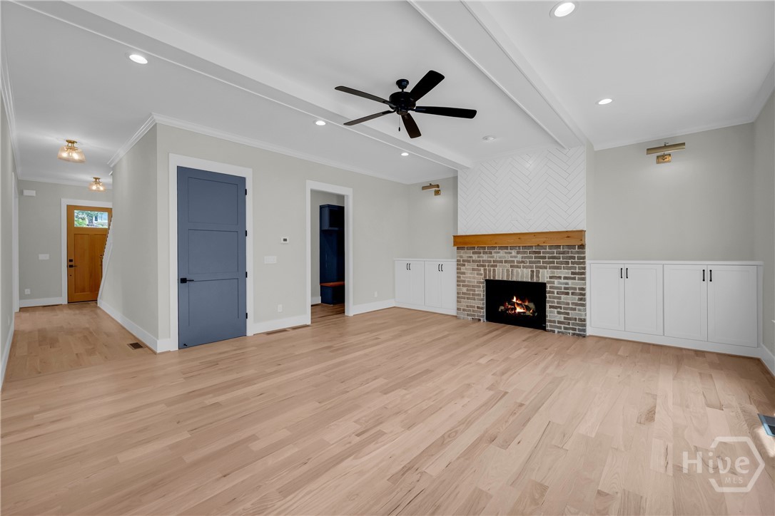 Spacious family room featuring light wood-finish flooring and 10-ft ceilings on main floor