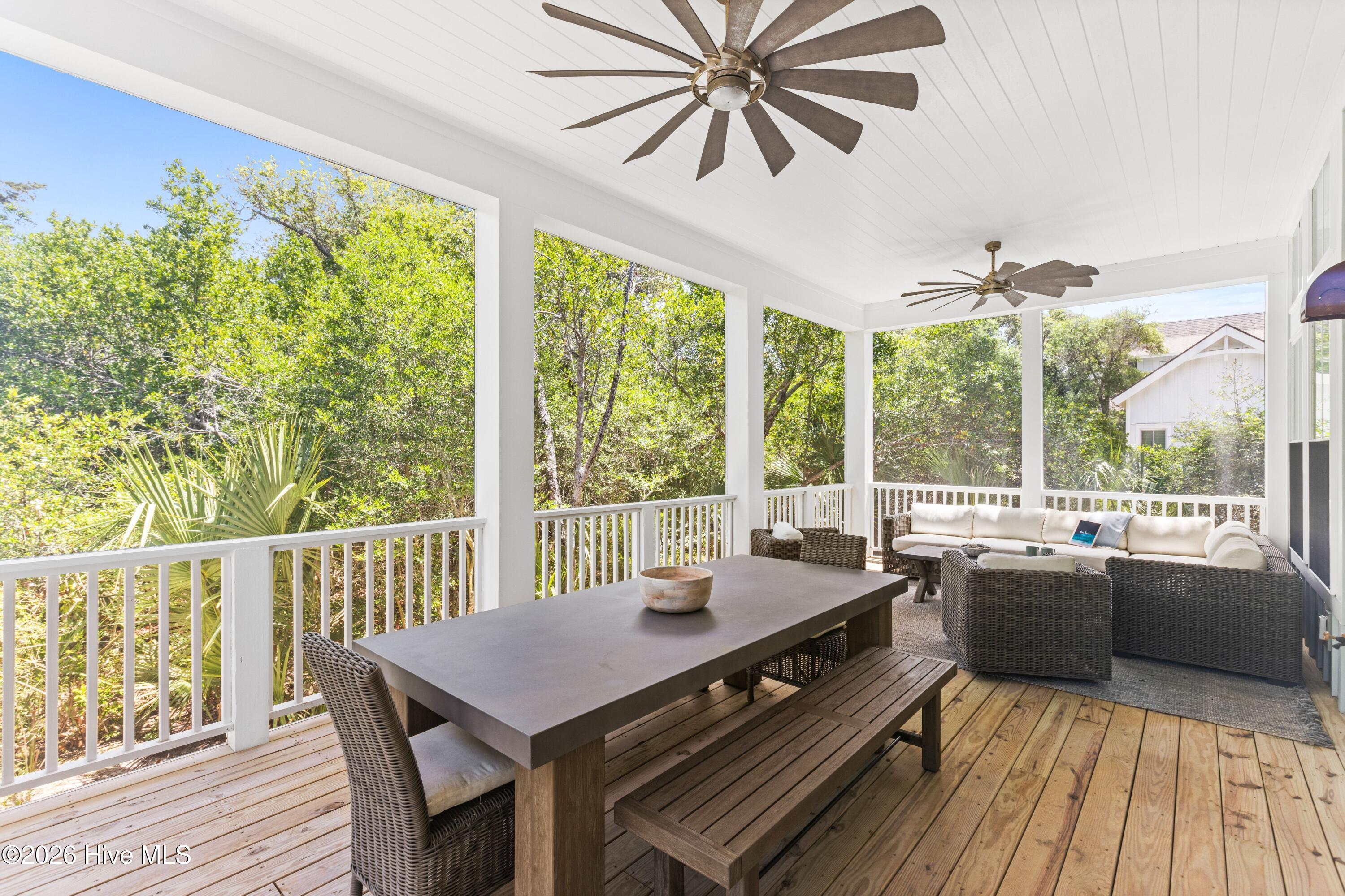 Screened-in porch with dining and seating areas