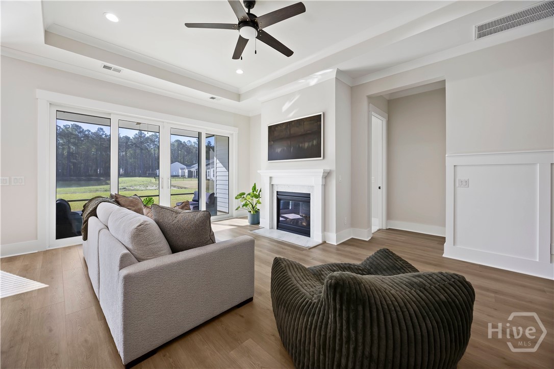 Large sliding glass doors open the living room to the screened porch, creating effortless indoor-outdoor living