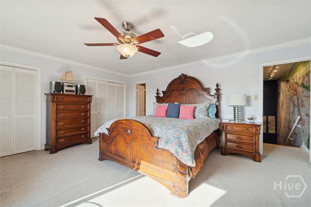 The primary bath is the open door to the left, the stairwell is on the right.  There are two primary closets.