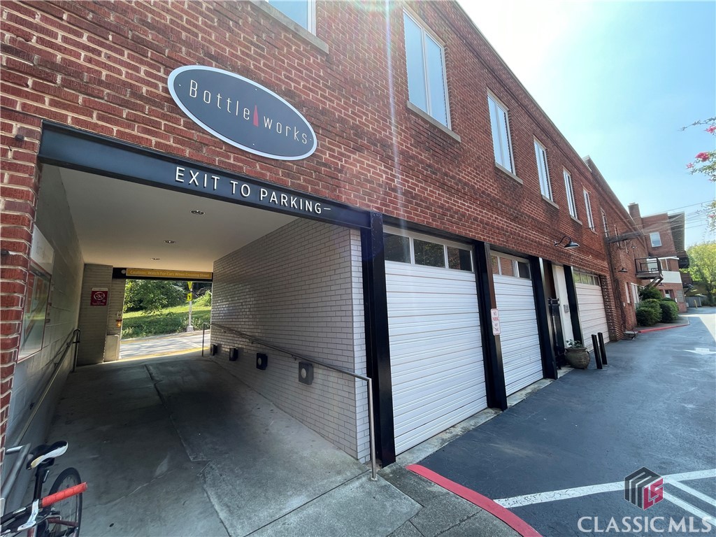 The Bottleworks is an iconic example of adaptive reuse in Athens with some of the most bustling restaurants, retail, and office spaces with condominiums above. This condo is the largest of the ones on property with a 2-car garage with garage door, gated courtyard entry, high ceilings, exposed brick walls, and beautiful original hardwood floors from the original warehouse. The floor plan is open and great for entertaining. There is a screened-in corner porch where you can enjoy views of two different streets and engage with passersby. The two bedrooms are generously sized, and there is an additional nook for an office. Sold before published.