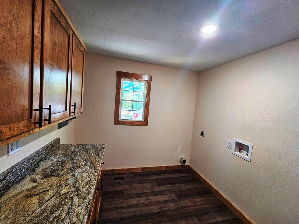 Beautiful Laundry room with cabinets and granite c