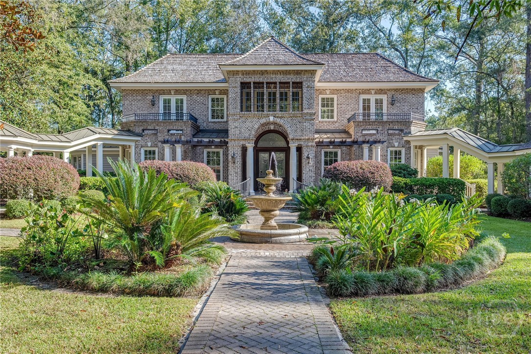 Discover unmatched luxury at this exquisite estate, nestled on a secluded lot in the prestigious Ford Field & River Club. A brick walkway, lush greenery, and a timeless fountain lead to the home’s elegant entrance. Inside, the light-filled living room flows effortlessly into the formal dining room, gourmet kitchen, and breakfast area, creating an ideal space for entertaining. The main-floor primary suite offers a serene retreat, while two upstairs bedrooms each boast private balconies overlooking the picturesque grounds. Relax on the screened-in porch, taking in tranquil views of the third hole of the award-winning Pete Dye golf course. A breezeway connects to a fully equipped guest cottage and a charming carriage house above the garage. ***Seller will include the $200,000 initiation fee with the sale of the home!!