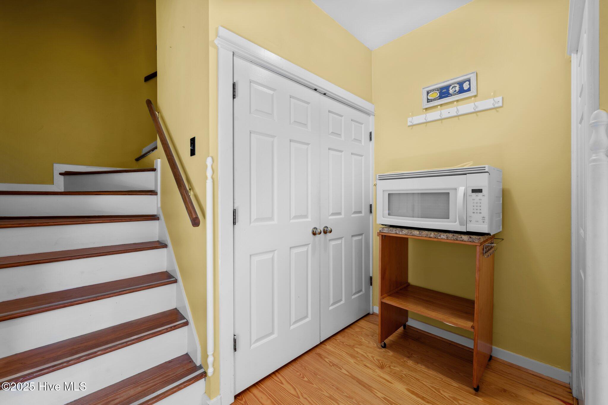 Laundry Closet & Stairs that lead toPrimary Bedroom