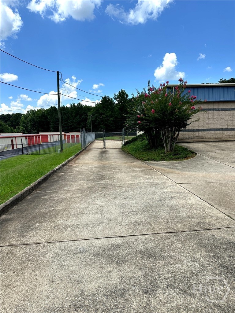 Rear yard with chain-link fencing and barbed wire