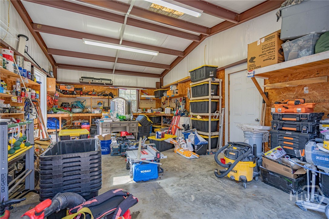 Insulated shop with electricity, shelving and bay door.