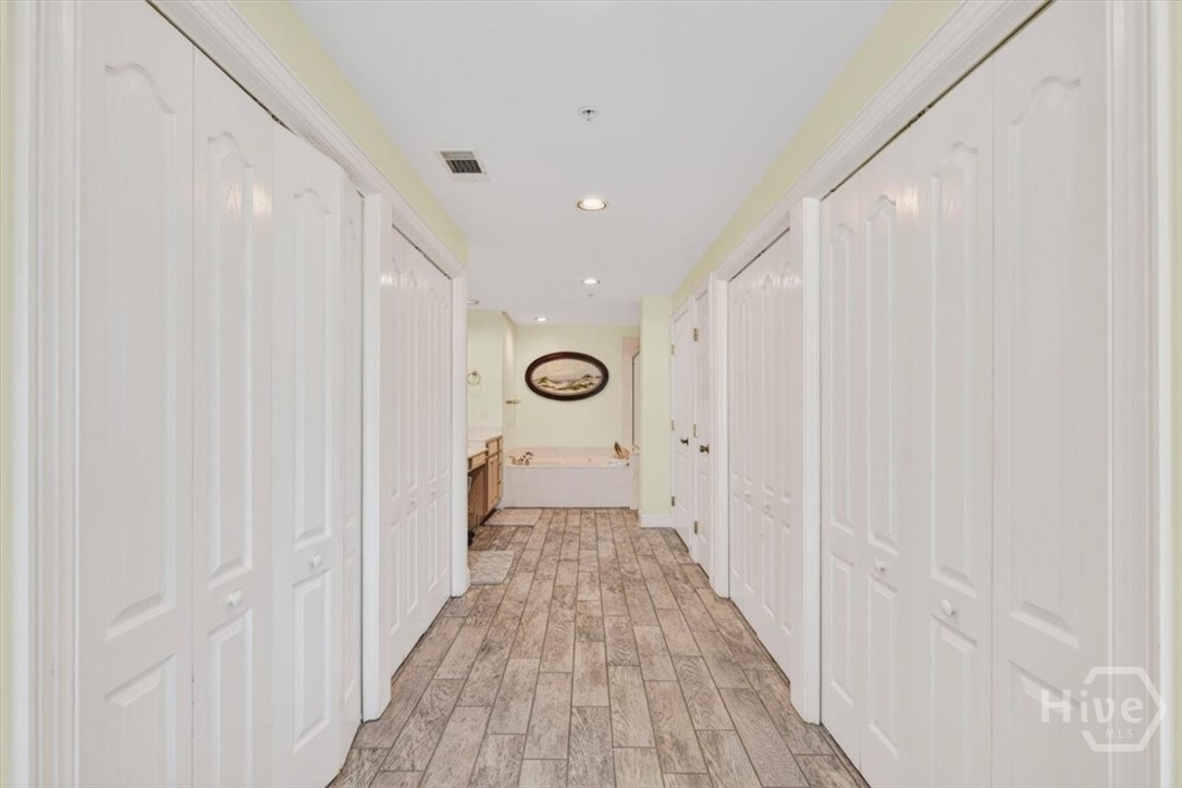 Huge primary en-suite offers ample closet space, a soaking tub, double vanities, and separate shower