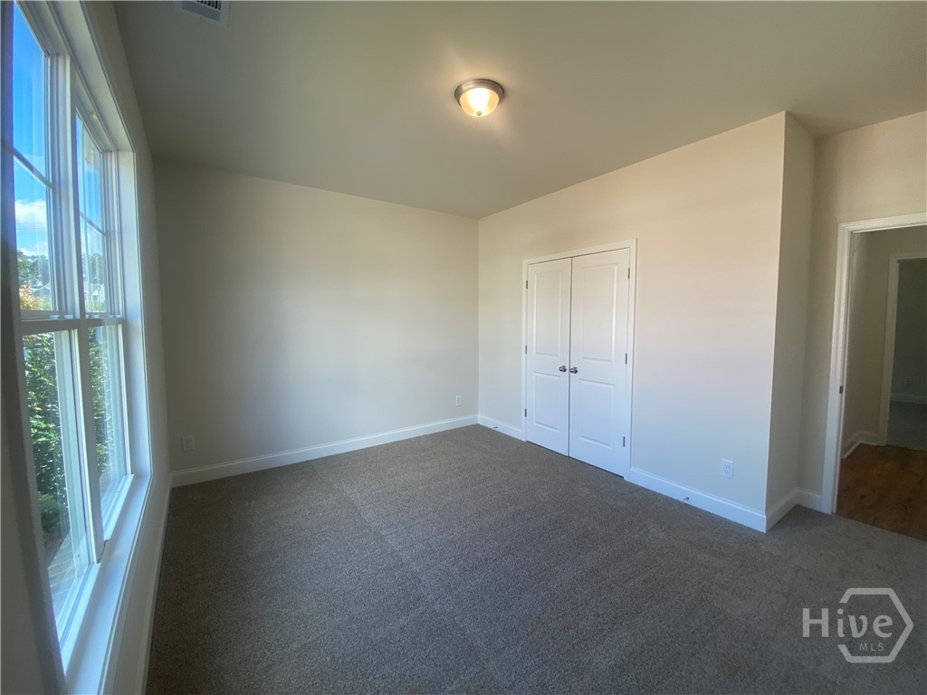 Guest bedroom with abundance of natural lighting