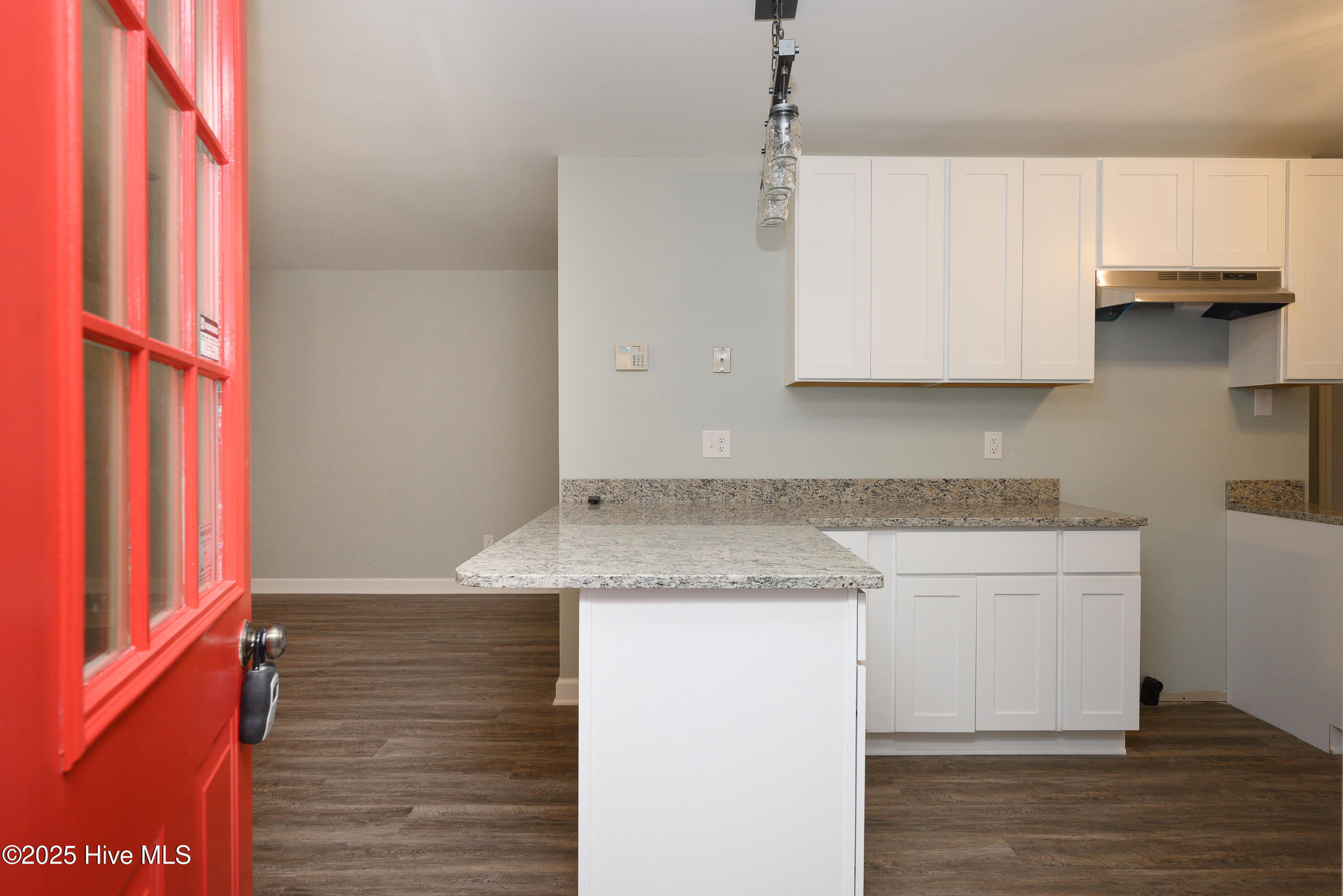 Front door opens to kitchen and living area