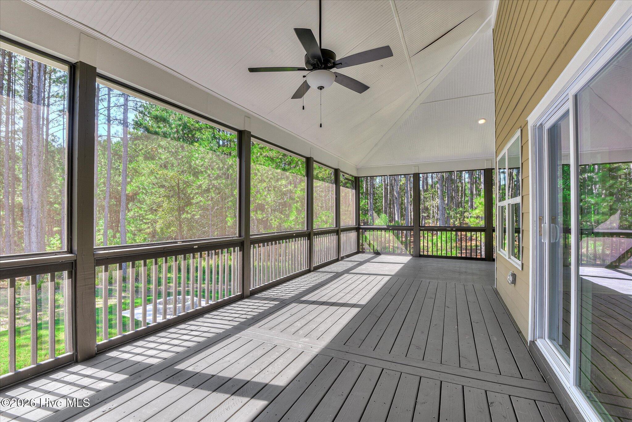Rear screened porch stretches down the right side and across the back of the home.