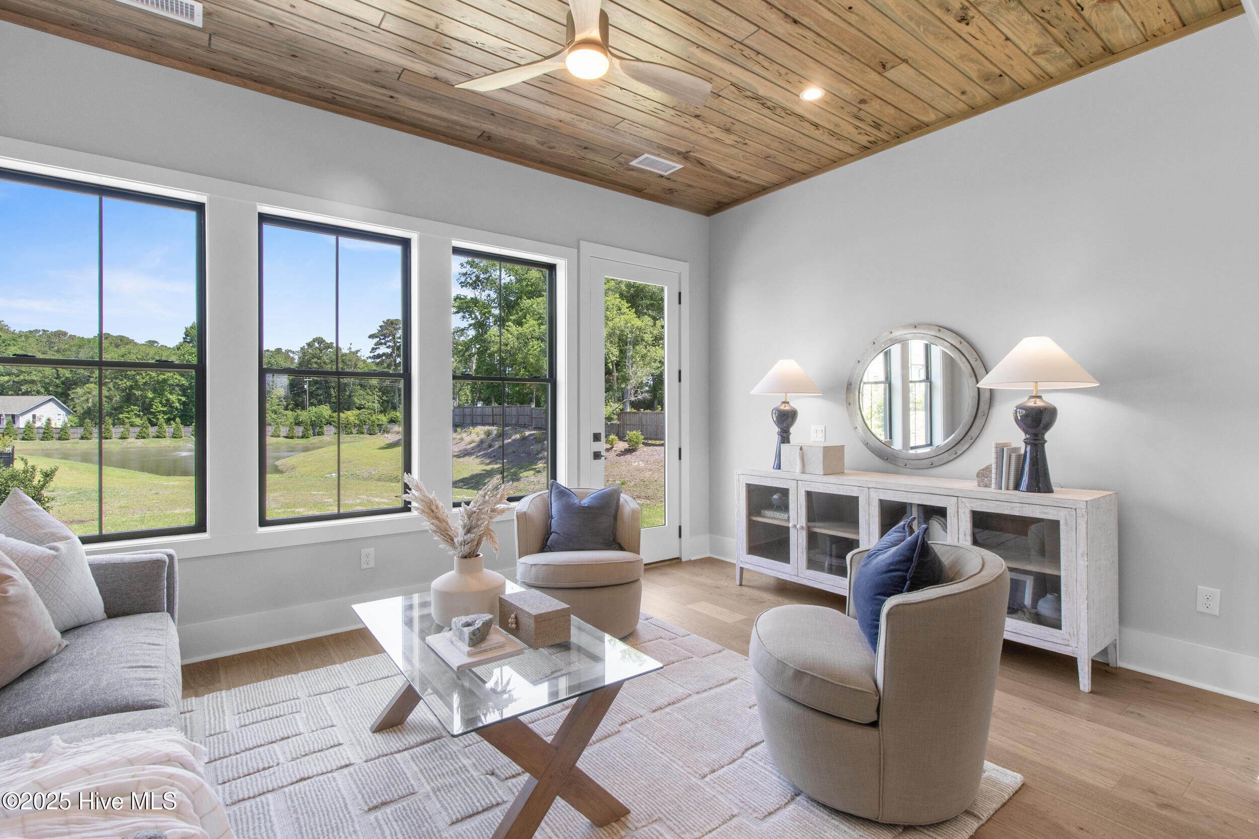 Sunroom with cypress ceiling overlooking pond and natural community green space!