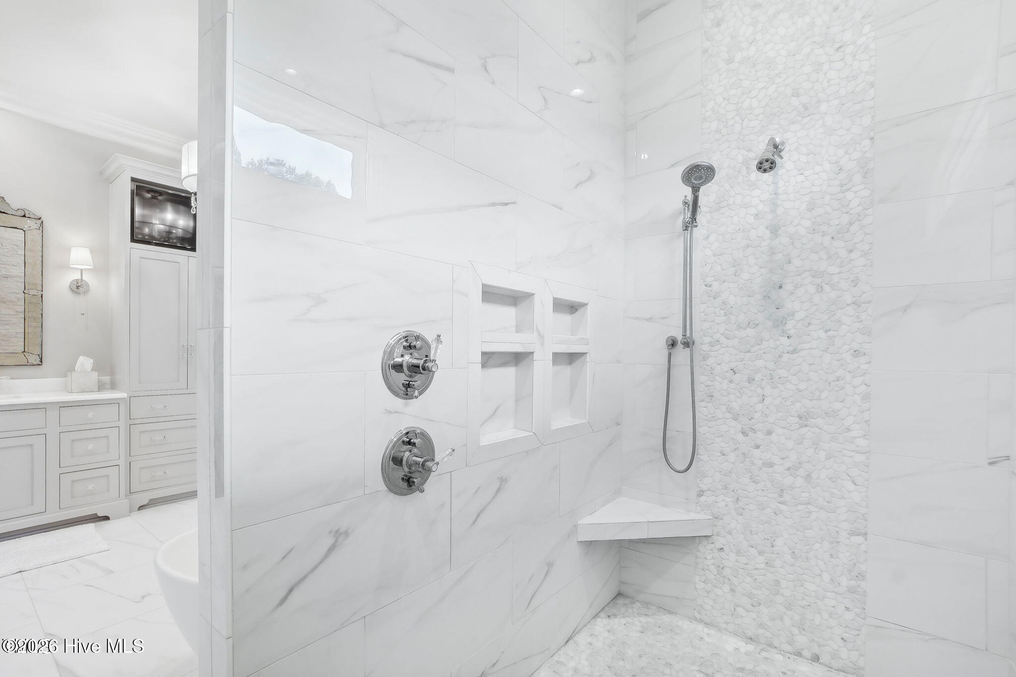 Walk-in shower with heavy plate glass door with rain head and handheld temperature control multi val