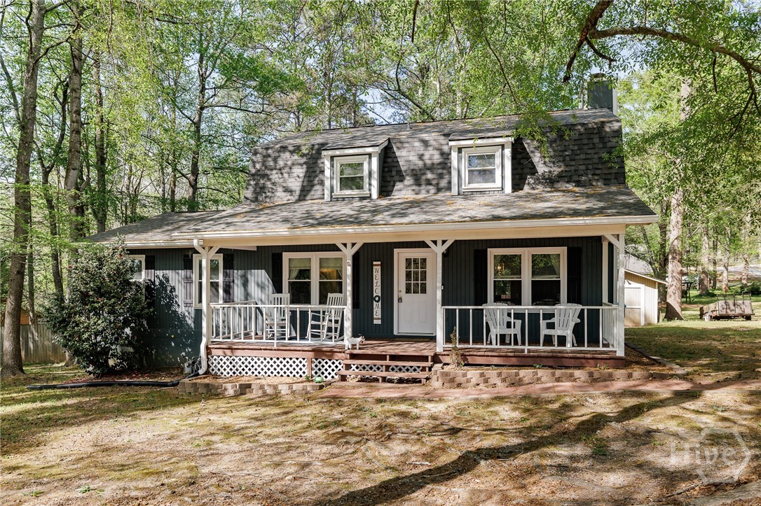 New Listing in Crawford offering big bang for your buck! Totaling over 1,900 square feet, three bedrooms, two full baths, and one half bath, there is a lot of great space. New roof in 2024 and new downstairs HVAC in 2022! The rocking chair front porch and rear deck are great spots to enjoy the outdoors. Living room with stone fireplace is open to both the dining area and kitchen. Off the kitchen is a sizable laundry room. The primary bedroom could easily accommodate a king size bed as well as additional furnishings, and the ensuite bath is quite large. Upstairs are two additional bedrooms sharing a hall bath. All bedrooms and bathrooms feature newer LVP flooring. Fenced backyard for Fido with workshop and storage shed for the handyperson in the family. Great corner lot with mature trees! Call your favorite agent to see this one today!