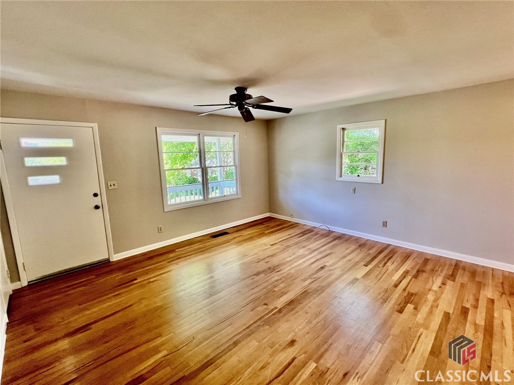 In-town 3/1 brick home with rare views of Downtown Athens from a high elevation lot. Watch the sun set over Downtown from front porch or LR windows. Only minutes from Downtown, UGA campus, the Oconee River, Greenway and Firefly Trails, 3 Parks; Chicopee-Dudley is the most green-centric intown neighborhood in Athens. The home has oak flooring in LR, DR, central hallway, and all 3 bedrooms. There’s a tile bath off the central hall. An addition off the left rear provides a secondary common living area, with natural wood ceilings. The home comes with a full set of appliances, including a stackable W/D in the laundry room. Parking is located behind house. This is an area where quite a number of stylish new 2-story homes have been built in recent years, as it’s about as close to Downtown as one can live, and thus enjoy the abundant offerings that come with intown living.