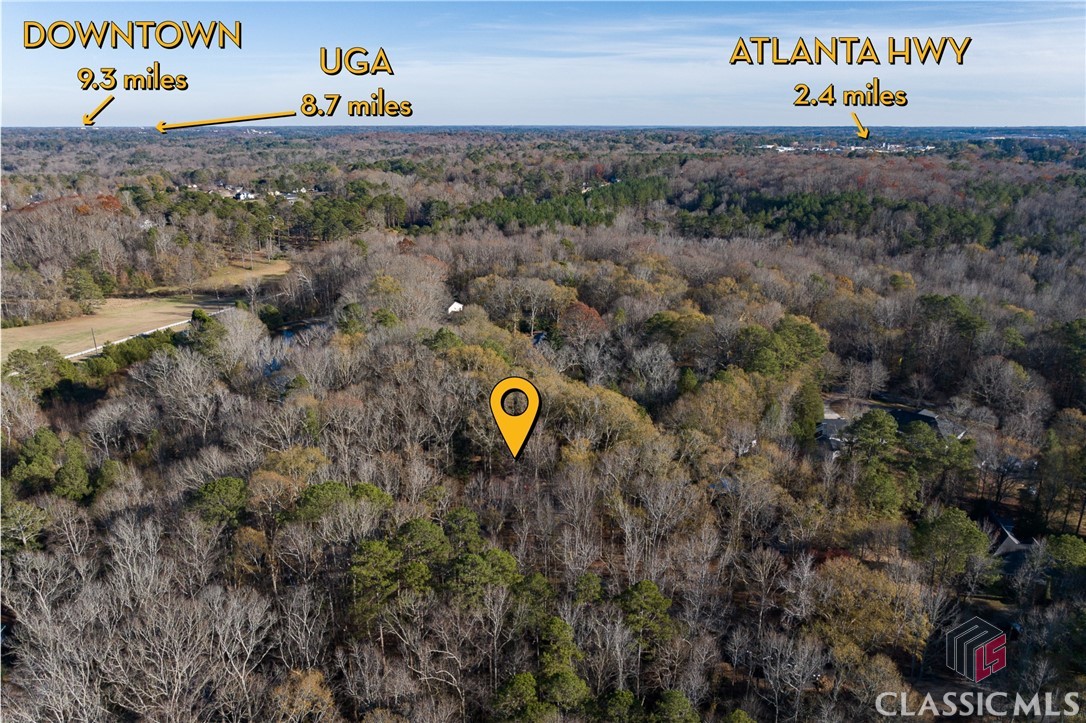 170 Hanover Circle is a quiet home tucked away at the end of a serene cul-de-sac, resting on  2.72+/- acres of beautiful Georgia land. This contemporary residence offers a welcoming, spacious, and open floor plan. The main floor is designed for easy living, featuring a primary suite that ensures accessibility without stairs. Generous kitchen, living, and dining room sizes provide ample space for relaxation or hosting gatherings.Upstairs you will find two bedrooms with a connecting jack and Jill bathroom. In addition the upstairs has a cozy loft, offering versatility and additional living space. Abundant natural light streams in through stylish casement windows, establishing a seamless connection with the outdoors. Enjoy the Georgia weather and entertain guests on the expansive screen porch and in the inviting sunroom.In addition to the main dwelling, the property includes a workshop, offering flexibility for hobbies, projects, or extra storage. This unique home combines modern aesthetics, spacious living, and the tranquility of a cul-de-sac locale. Make this residence your own and embrace the charm of living in Athens, GA.