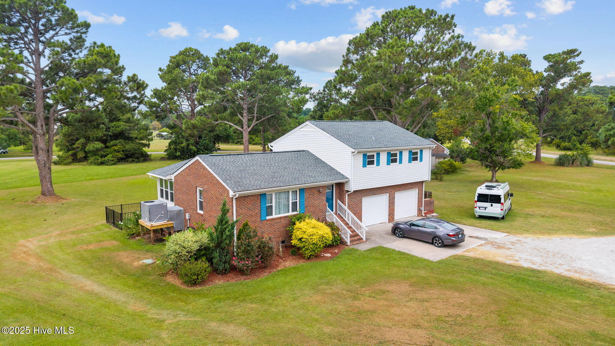 5302 Bogue Drive Oriental, North Carolina A lovely waterview residence in Oriental inclusive of extra lot, manicured and ready for you to call ''Home'' !
Situated on a vista lot in desirable Windward Shores with views of the Neuse River, this beautiful 3-bedroom, 2 1/2 bath,split-level home with an attached double garage, has been thoughtfully updated and expanded from its original design to take advantage of its beautiful surroundings. This offering includes TWO LOTS (.48 and .43 acres respectively), which promise privacy, elbow room, and investment value! Create a family compound or sell the extra lot later - There's has great flexibility. A must-see property featuring vaulted ceilings and numerous recent upgrades including a new HVAC, new master shower, kitchen appliances and a fenced backyard which is perfect for pets! The residence is comfortable, sunny and beautifully maintained. It also features quartz kitchen/bathroom counters, vinyl windows and a private outdoor area with views & cooling summer breezes from the Neuse! You'll love taking morning coffee on the 7' x 13' elevated deck and evening cocktails on the patio under the lovely 14' x 11' pergola! The Living room invites you into a bright and cheerful interior with vaulted ceilings and partly open to the kitchen, allowing the cook to visit with family & friends. The Sunroom will draw you in with its bank of windows with new shades/blinds... It would be a great spot to watch the boats out on the River and a cozy, sunny place to curl up with a good book on a chilly day. The public areas flow well and the home lives larger than it might appear. Enjoy the Vista lot and in's unobstructed views and feel free to launch your boat from the Community boat ramp for a day of sailing or fishing on the finest waters in Eastern NC! There's so much to appreciate with this residence...A fantastic value for the discerning buyer.