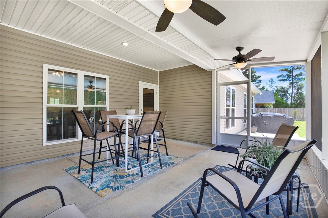 Lovely screened in porch overlooking the pool and beautiful, peaceful backyard.