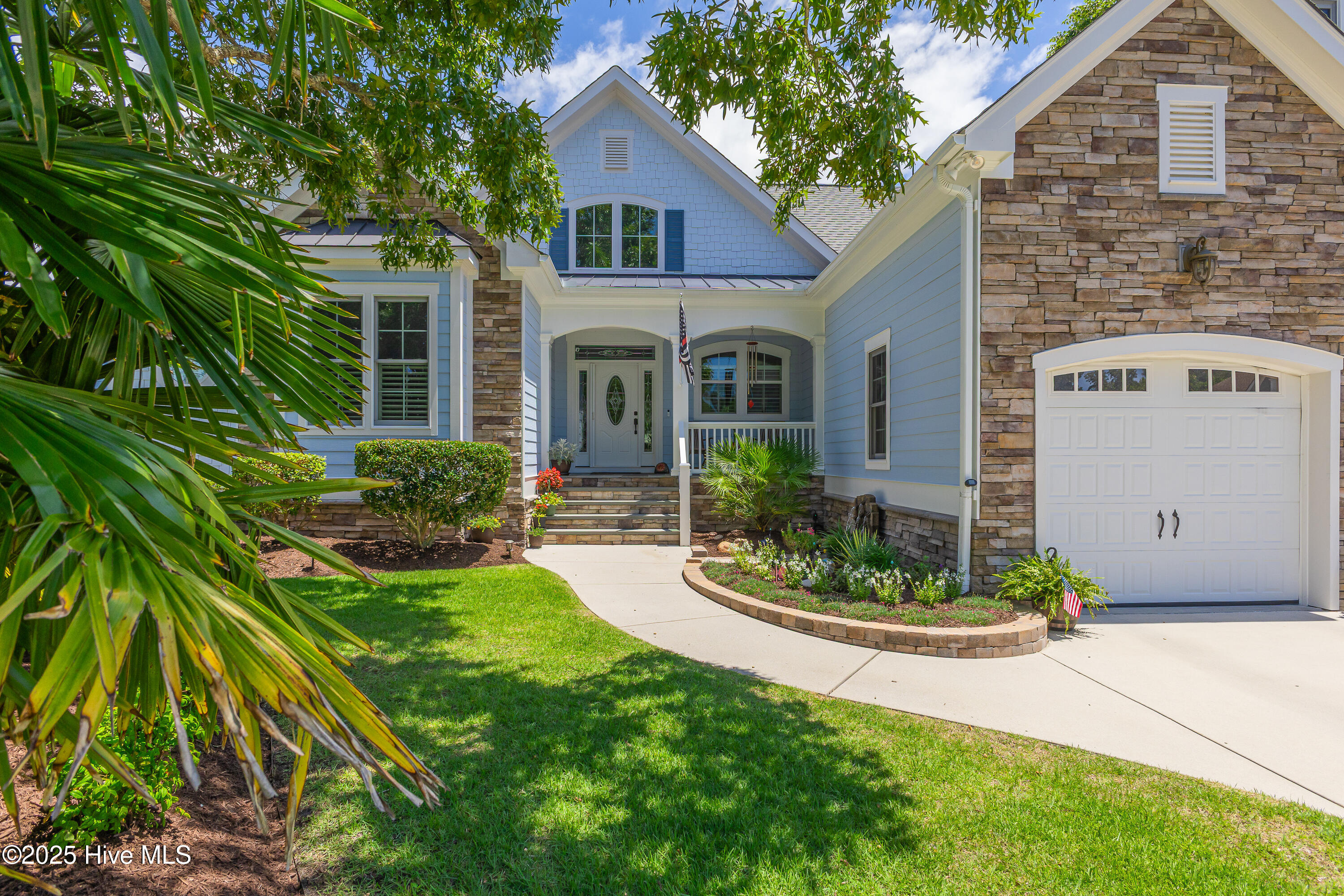 Welcome to your dream coastal retreat, where quality craftsmanship meets serene living. This 4 bedroom, 3.5 bath home offers a meticulously designed escape with 2,794 sq ft of living space tucked at the end of a cul-de-sac.  Inside, you'll find custom touches designed with a focus on comfort & style. The main floor provides an open concept living area showcasing a stone fireplace, offering both charm & warmth. Adjacent to the living area is a chef's kitchen, offering plenty of prep & storage space.  Just off the kitchen you will find a spacious dining area, the perfect setting for gatherings.  Tucked into the corner of the home is a Carolina Room, a peaceful sanctuary!  The generously sized primary bedroom features a walk in closet  & en-suite bathroom complete with a walk-in shower. Another feature of this home is the recently enclosed sun porch, offering year-round views of the serene pond behind the house. Imagine sipping morning coffee or unwinding in the evening while watching the sunlight glint off the water.  2 additional guest bedrooms on the 1st floor share a full bath & the front bedroom features a 6 X 6 ft. office or craft room.  Upstairs there is a bonus room with full bathroom perfect for guest quarters or additional flex space. There is no lack of storage with 442 sq ft of walk in & floored attic space. The home also includes a two-car garage with a workshop area ideal for projects.  Every detail here, down to the expoxied floor, is well-maintained & organized for function & purpose.  Winding River delivers an exceptional coastal lifestyle. Whether it's enjoying the community pool, fitness center, clubhouse or the Riverhouse with its ten-slip marina, there's something here for everyone.  If the waves are calling, there's an oceanfront Beach House & pool.  So, if your dream involves casting a line or enjoying sunsets by the water, this home delivers.  Let the tide bring you home to a space where craftsmanship & coastal beauty converge.