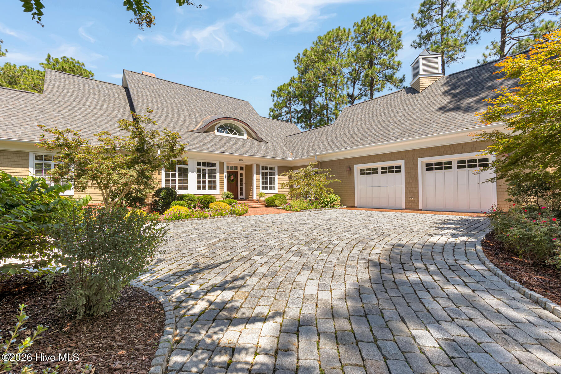 Discover the rare opportunity to own a beautifully appointed home in Fairwoods #7, ideally situated overlooking the 4th green of Pinehurst No. 2 and the tee box of Hole #5. Surrounded by gorgeous, mature trees and thoughtfully designed landscaping, this serene property offers a peaceful setting for morning coffee and spectacular evening sunsets. The home blends timeless character with thoughtful updates and exceptional livability. The inviting living room features a gas fireplace, while the spacious family room offers a wood-burning fireplace, built-ins, and a wonderful gathering space. The kitchen is beautifully equipped with granite and slate countertops, a Sub-Zero refrigerator, gas range, warming oven, and generous storage, including a large walk-in pantry. The luxurious primary suite is designed for comfort and privacy, featuring a large master bath with separate his-and-hers bathrooms, a walk-in shower, and his-and-hers closets. Three additional upstairs bedrooms each feature their own en-suite bath, providing exceptional accommodations for family and guests. Additional features include a new roof in 2025, large laundry room, office with built-ins, cedar-lined walk-in storage closet, oversized garage, unfinished storage space above the garage, and a beautiful stone driveway. Electric screens on the back patio create an ideal outdoor living area, while the fire pit provides the perfect spot to unwind beneath the trees. For those who love the Pinehurst lifestyle, the location is hard to beat. Walk, bike, or take your golf cart into the Village of Pinehurst for lunch, dinner, and shopping. A transferable Pinehurst Country Club membership is also available. Live where golf history is made and enjoy the best view of the 2029 U.S. Open from your back yard. Peaceful, private, and exceptionally well located, this Fairwoods #7 home offers the quintessential Pinehurst lifestyle--with beautiful golf-course views, mature landscaping, generous living spaces, and effortless access to the Village and Pinehurst Country Club.