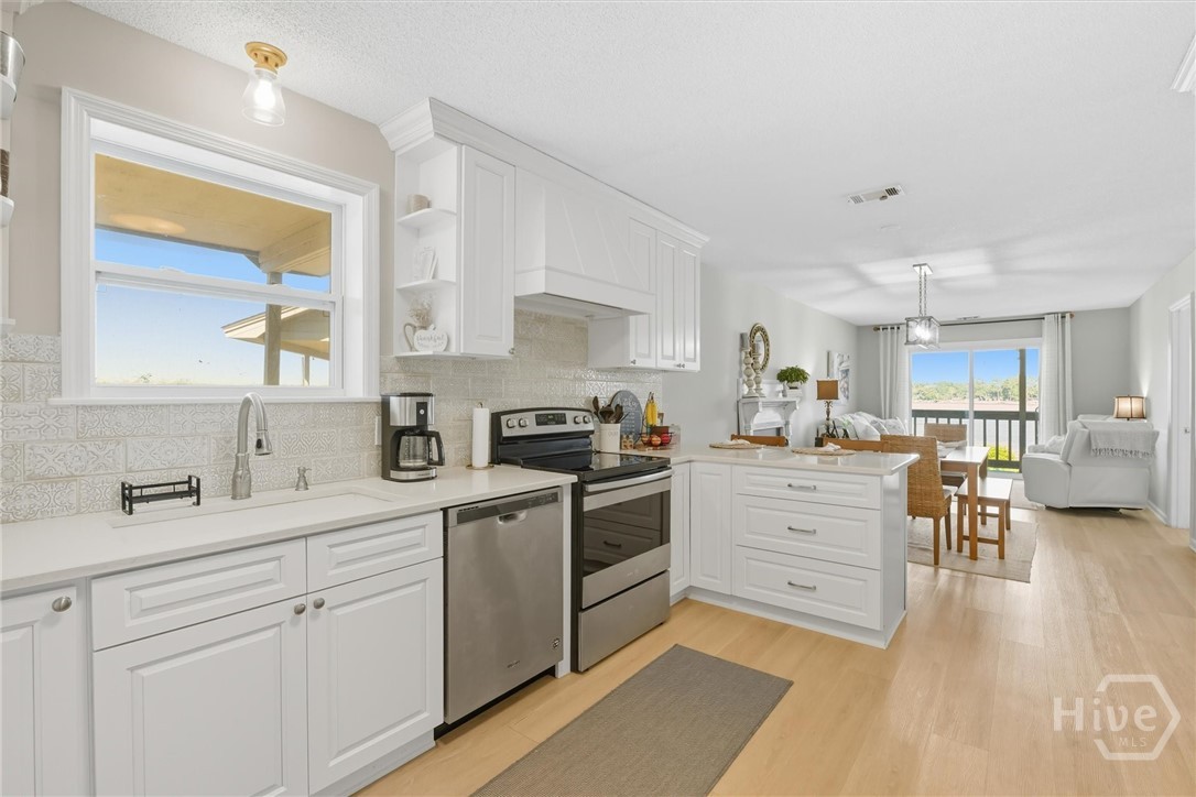 The kitchen offers real wood cabinetry.