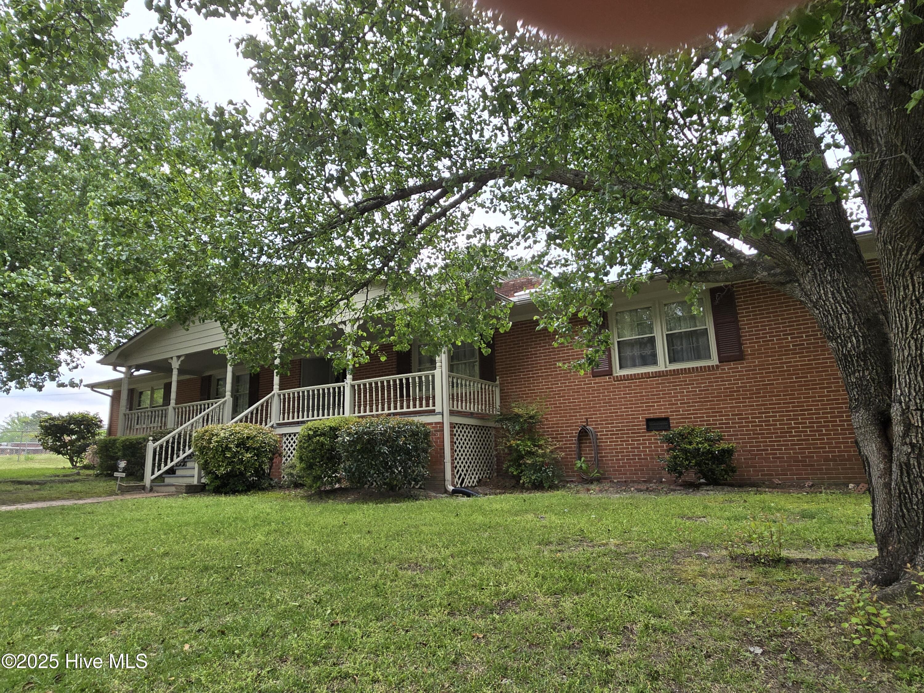 Brick home on corner lot in the city limits features five spacious bedrooms and 2 and a half baths.  3206 Sq. feet living space.  Has finished basement.  Large kitchen, living room and a cozy family room with gas fireplace.  Garage, large front porch for friends and family to sit and relax. Patio on back.  Perfect size home for family gatherings and entertaining.  Owners are offering a $3500 carpet allowance to buyers.