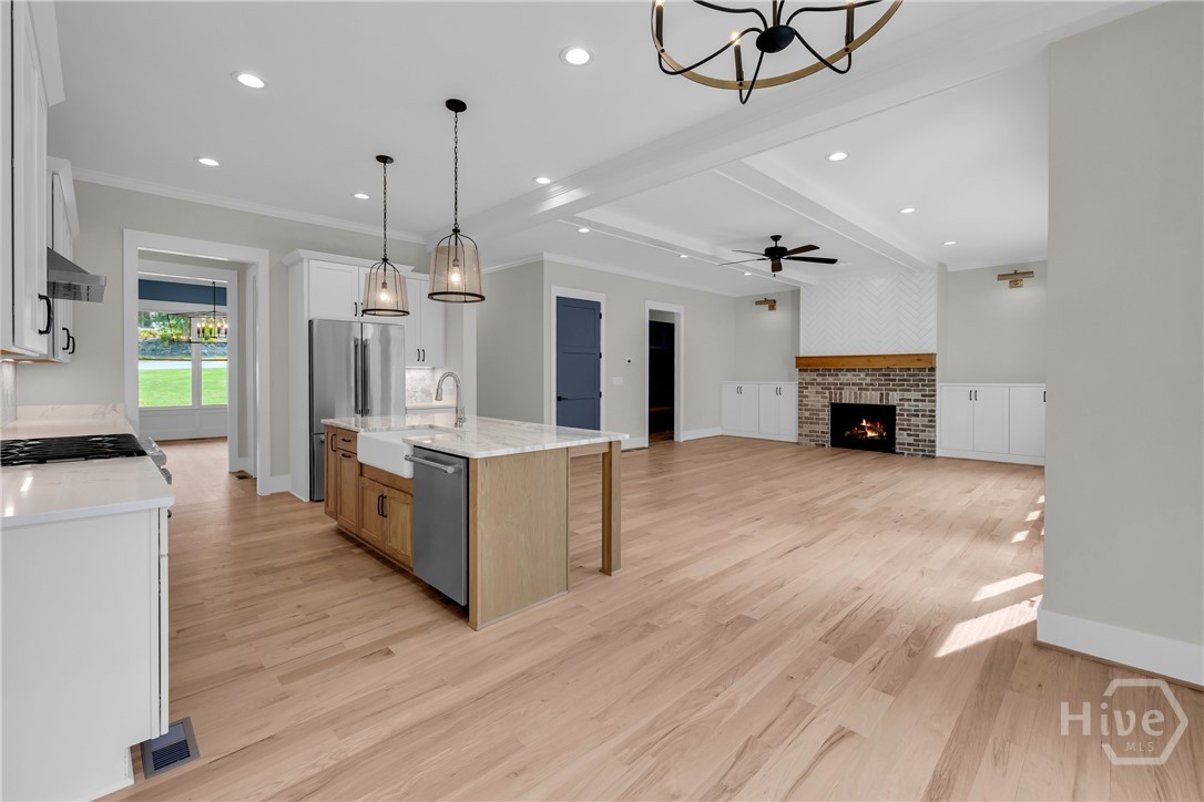 Stunning chef’s kitchen featuring marble and quartz countertops, a complete Thermador stainless steel appliance package, 5-burner natural gas cooktop, dedicated coffee station, and an impressive butler’s pantry for added storage and entertaining convenience