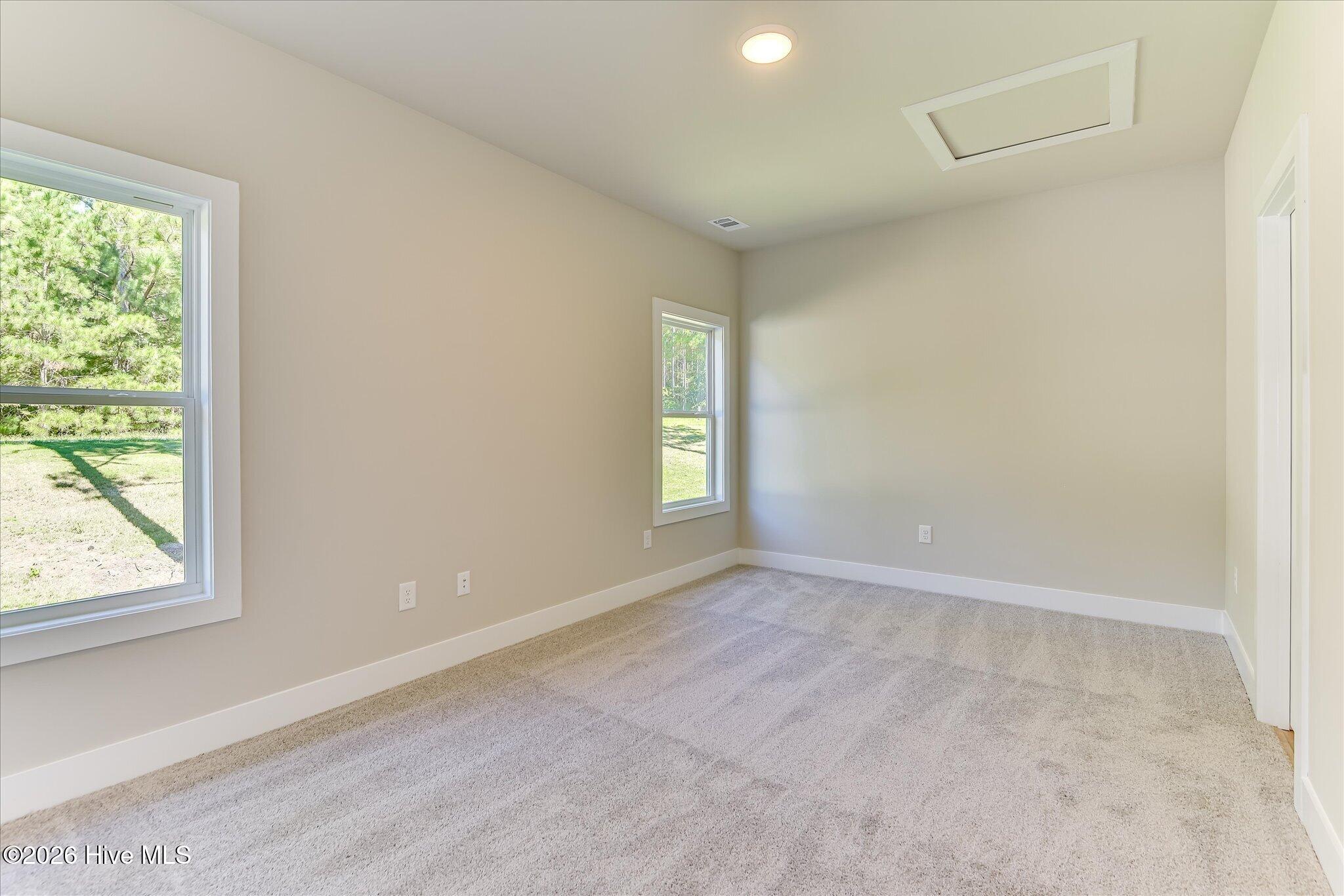 Bedroom 2 is downstairs and has shared access to the full hall bathroom.