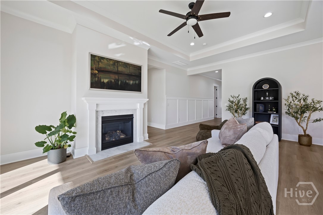 The spacious great room features a tray ceiling and fireplace