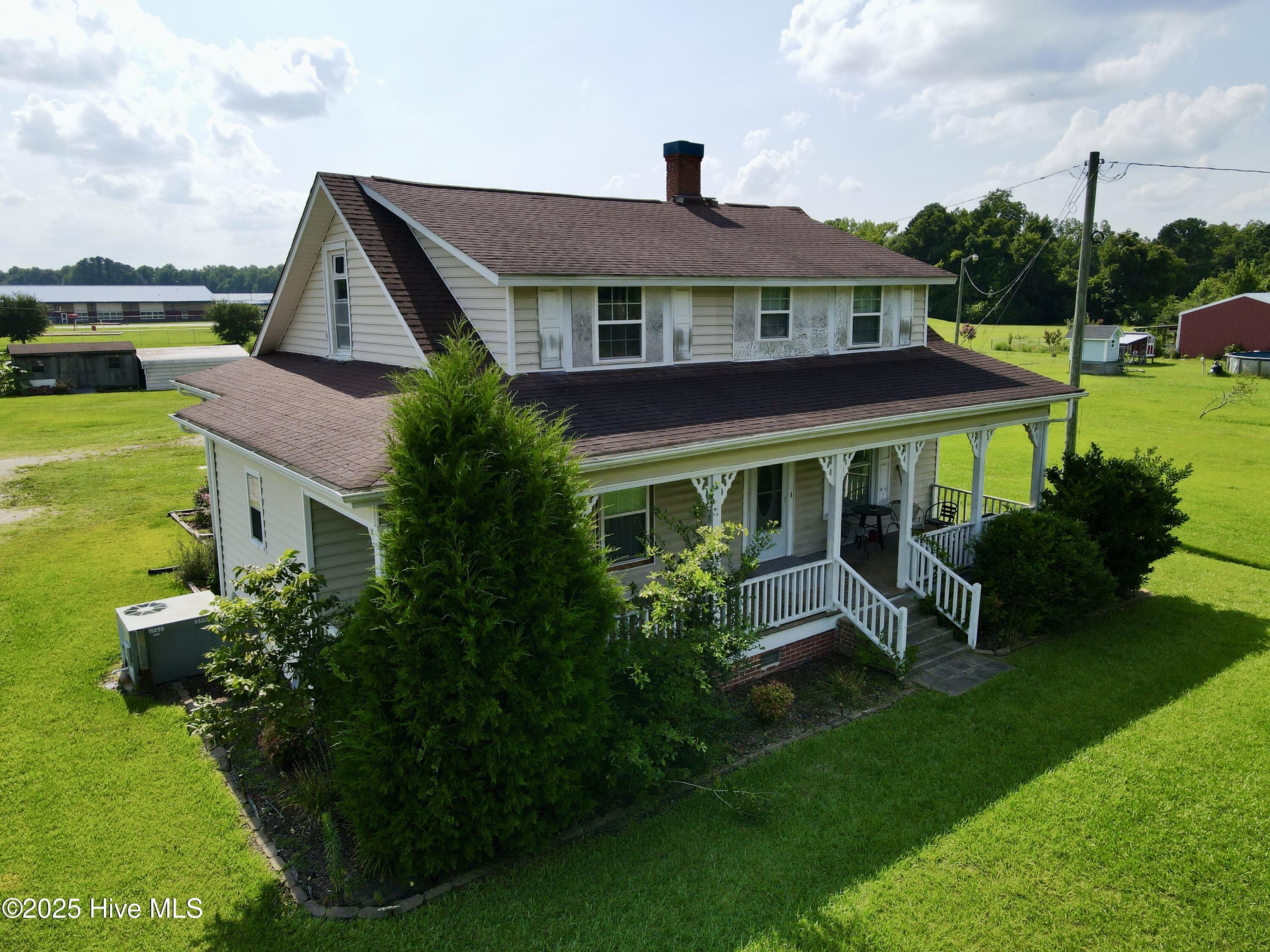 Discover the perfect blend of rustic charm and modern comfort with this exceptional 2-bedroom, 2-bathroom, 1.5-story farmhouse. Nestled on 2 cleared acres of serene countryside, this home offers a tranquil escape with all the conveniences you need.
Step inside to find a thoughtfully designed layout featuring a formal dining area, a deluxe master suite with a spacious bathroom, and abundant wardrobe space. There are two additional bedrooms upstairs but are not calculated in permanently heated sq footage total. The kitchen comes fully equipped with all appliances—including a washer and dryer—making it move-in ready. A cozy mudroom adds practicality, while the carport and outbuildings provide extra storage and functionality.

Imagine yourself unwinding on the covered front porch, gently swaying on a warm summer day, surrounded by the lush greenery of grapevines and apple trees. The attic offers endless possibilities, with ample space to create up to two additional bedrooms and a bathroom with a bit of renovation.
Conveniently located near schools, shops, dining, and leisure facilities, this property combines the peace of country living with easy access to modern amenities. Whether you're looking for a forever home or a weekend retreat, this farmhouse is ready to welcome you.

Don't miss the chance to make this charming countryside haven your own!