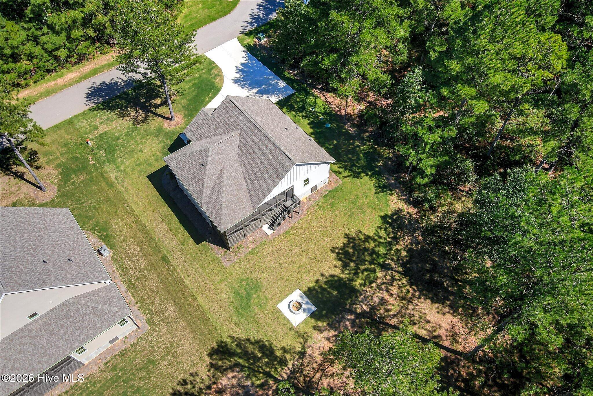 Large backyard with fire pit and trail to the lake, lot is dockable when water levels return to normal.
