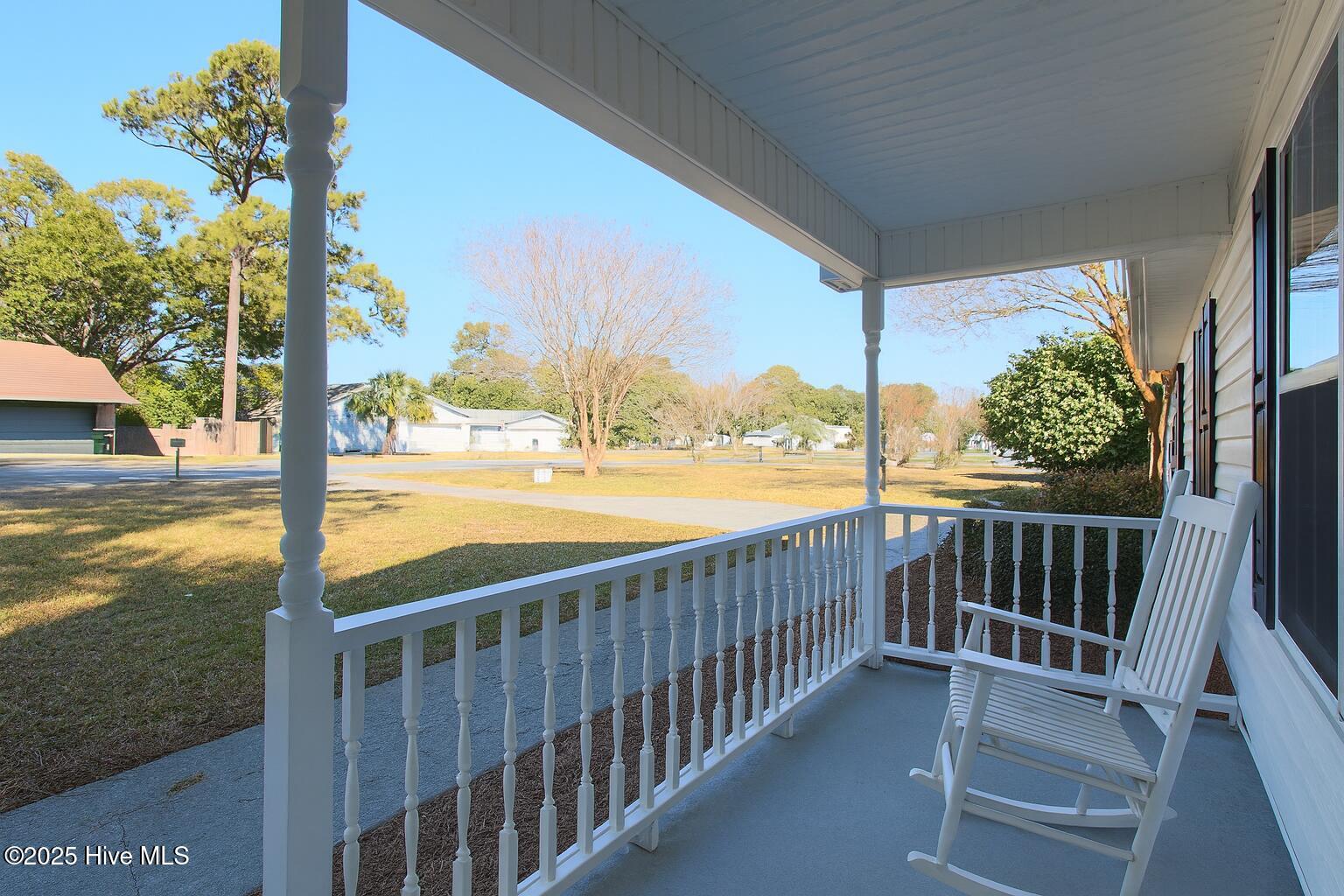 9117 Landing Drive SW, Calabash, NC 28467 – photo 3: Suburban Porch and Neighborhood Serenity