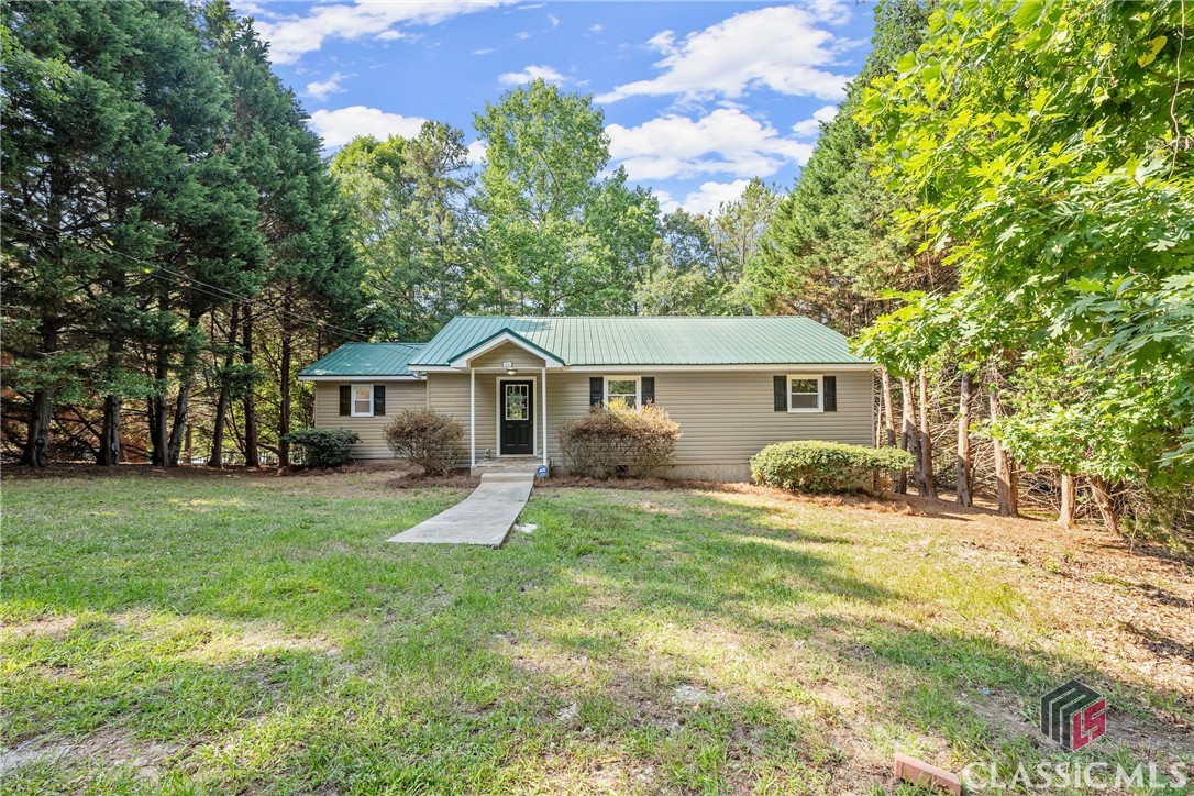 DISCOVER your dream lakefront retreat on the stunning shores of Lake Hartwell. This beautifully updated home offers the perfect blend of comfort and style, ideal for both weekend getaways and year-round living. The open concept kitchen and great room offer ample space for cooking, dining and entertaining, while the stone fireplace provides a cozy and warm place to UNWIND on those cooler nights. ENJOY the crisp, clean look of the recently painted interior surfaces and the stylish durability of the new waterproof laminate flooring. The home features a split bedroom plan, offering additional privacy to you and your guests. Once you've made the inside your own, STEP outside to the large deck and indulge in a good book or cup of coffee overlooking the serene lake. Enjoy a short and gentle walk down a natural path to the lake. An improved walkway has been COE approved. At the shore you'll find a large dock with a single slip, complete with a boat lift modified for a pontoon. V-hull hardware is also included. The dock offers incredible views of the deep open water that you can enjoy from your hanging swing - a perfect and peaceful spot to enjoy the sunrise. This charming lakefront home offers a rare opportunity to enjoy all that Lake Hartwell has to offer. Whether you're seeking a peaceful weekend retreat or a permanent residence, this home is ready to welcome you with open arms. Don't miss out on this incredible opportunity to own a piece of paradise.