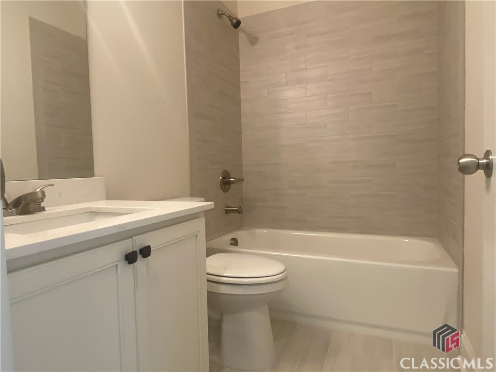 Guest bathroom with tile shower walls and bathroom