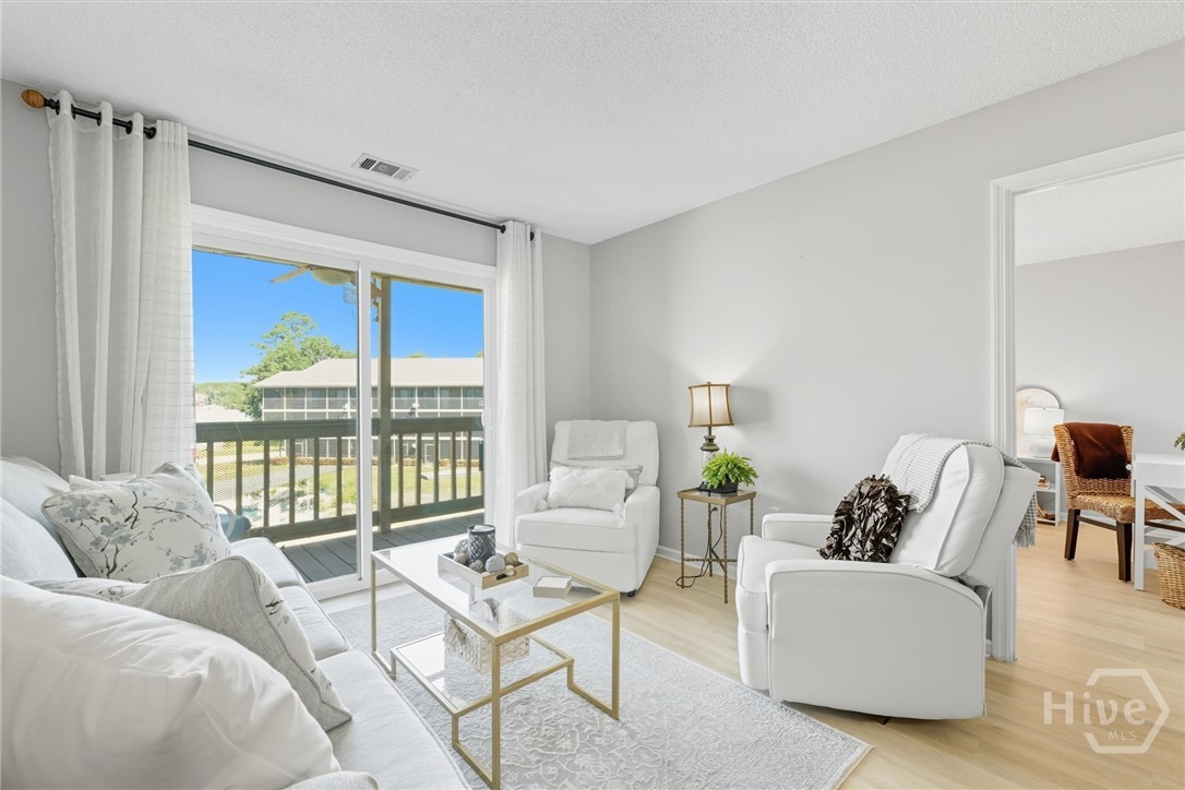 The living room has a sliding door to the balcony.
