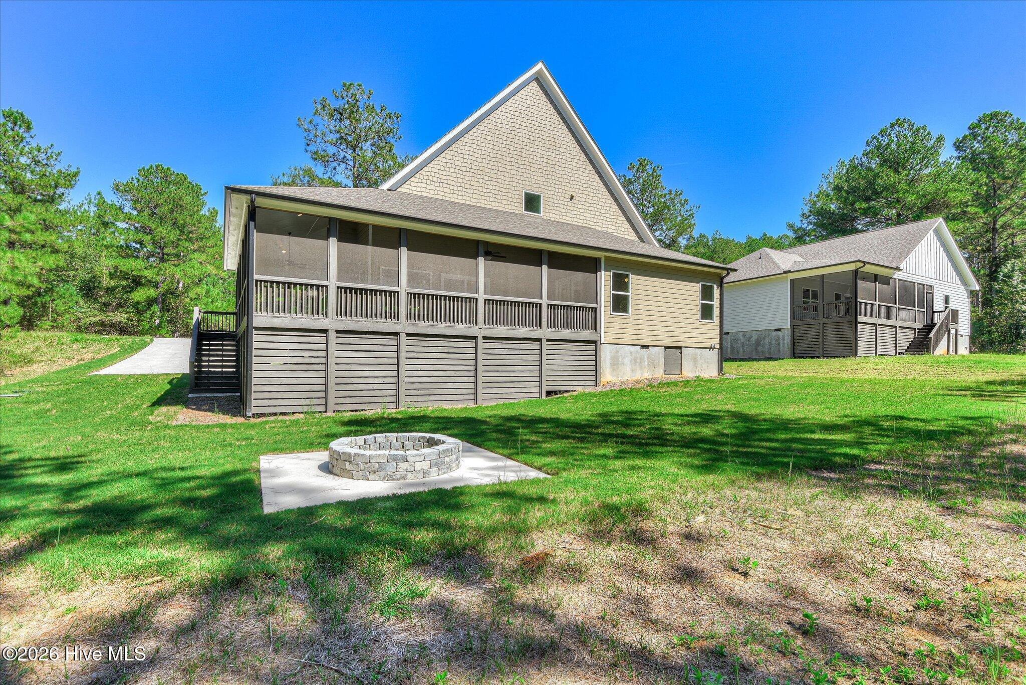 Large backyard with fire pit and trail to the lake, lot is dockable when water levels return to normal.