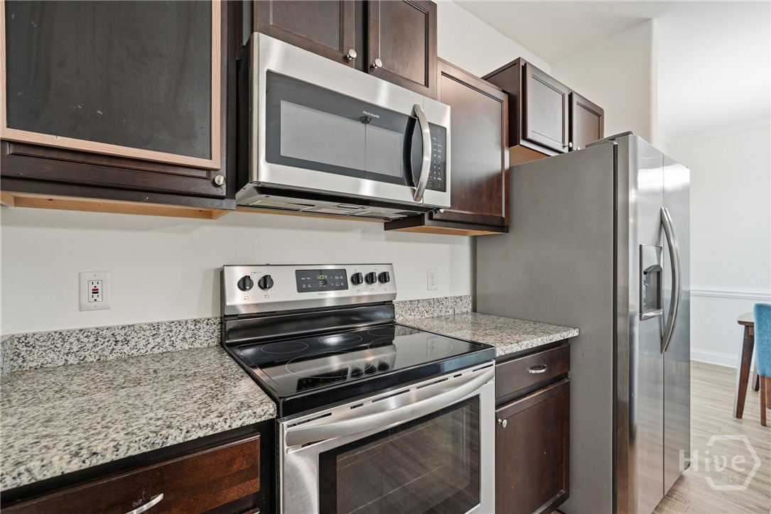 Kitchen is equipped with stainless appliances.